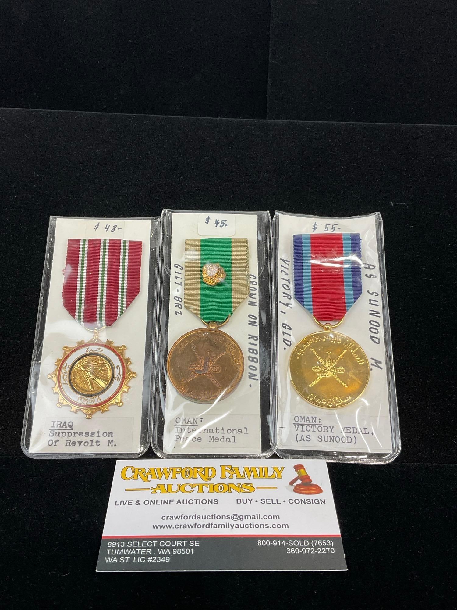 3 Medals, Iraq Suppression of Revolt + 2x Omani Medals, Intl. Peace Medal & Victory Medal As Sunood: All from a single collection, these are briefly described on the tag and were kept in a display. They measure approx 6h x 3w x 2d inches. See pics. E-5300 