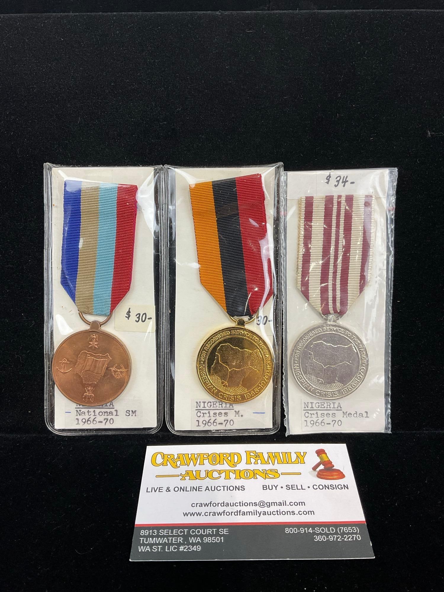 3 Nigerian Medals, National Service Medal 1966-1970, 2x Crises Medals 1966-1970: All from a single collection, these are briefly described on the tag and were kept in a display. They measure approx 6h x 3w x 2d inches. See pics. E-5300 