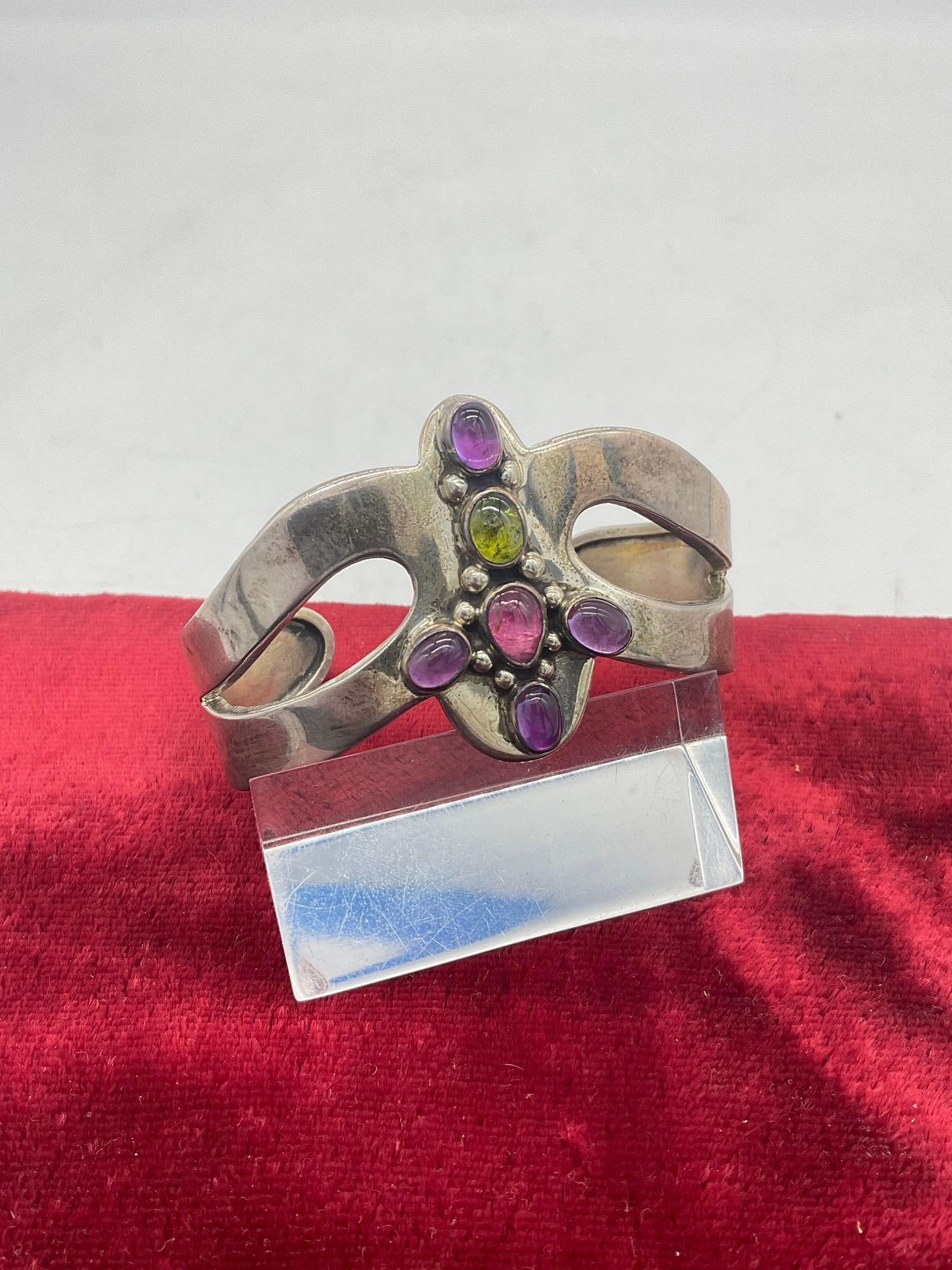 1991 SW Native American Design Sterling Silver Cuff Bracelet marked by Carol Felly: C-5320 Features Purple and green Gemstone cross bracelet is 2 1/2 " in width 36.88 grams 