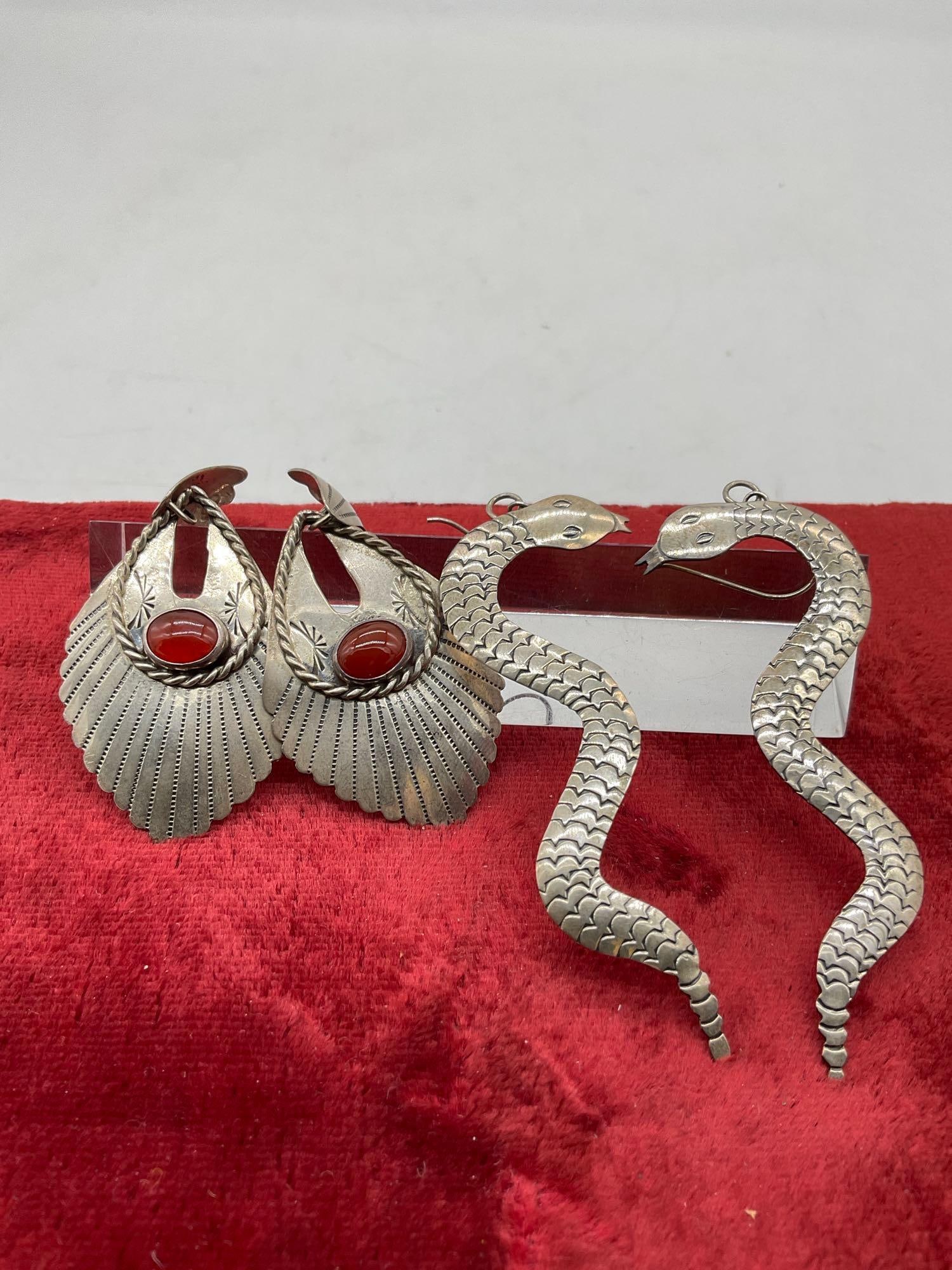 2 x Vintage Navajo Signed earrings Rattle Snake Dangles By Chester Geurro, & Dangles Signed AA: C-5320Vintage Pair of hand crafted sterling silver earrings Signed by Renowned Navajo artist CG & AAThe dangles Signed AA are most likely crafted by Aaron Anderson and features red stone