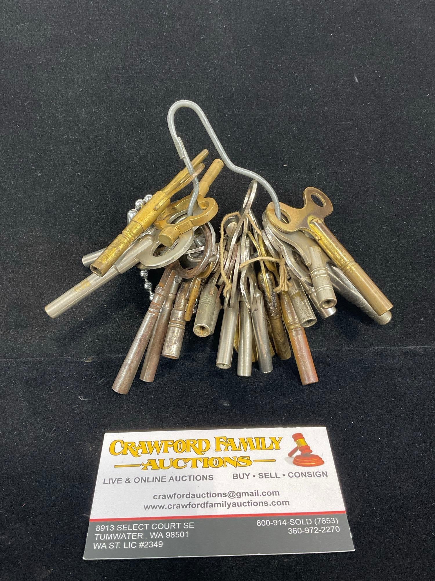 Large Assortment of Clock Winding Keys, on hook, Steel, Brass & Bronze, 5h x 6w x 5d inches: Appears to be in good shape. The piece measures approx 5h x 6w x 5d inches. See pics. E-5360