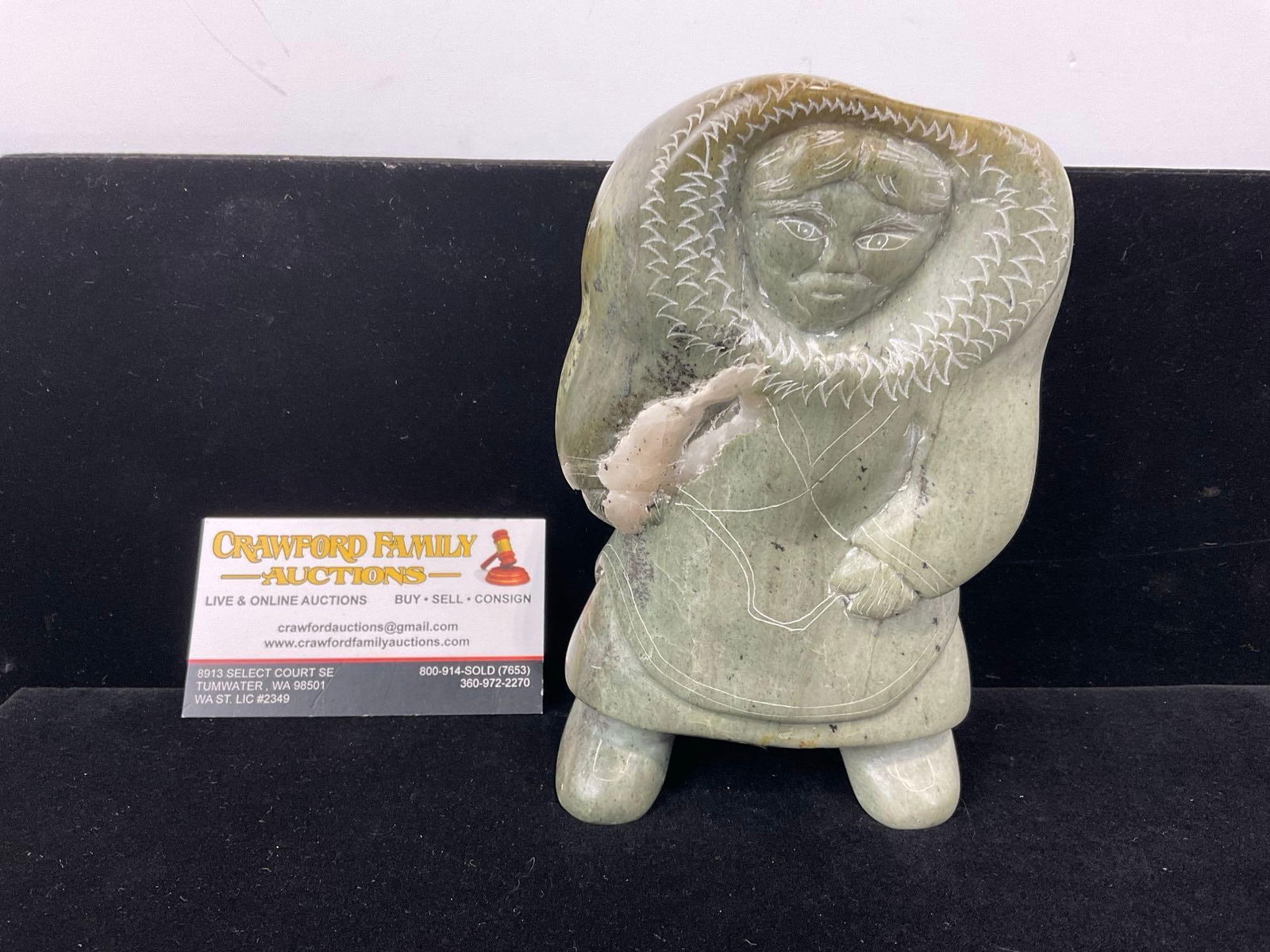 First Nations Handcarved Stone, Canada Eskimo Art, Green tone stone, 7h x 5w x 4d inches: Alakan Inuit art Looks to be possibly signed on the left foot pad, also some scratches. Appears to be in good shape. The piece measures approx 7h x 5w x 4d inches. See pics. E-5390
