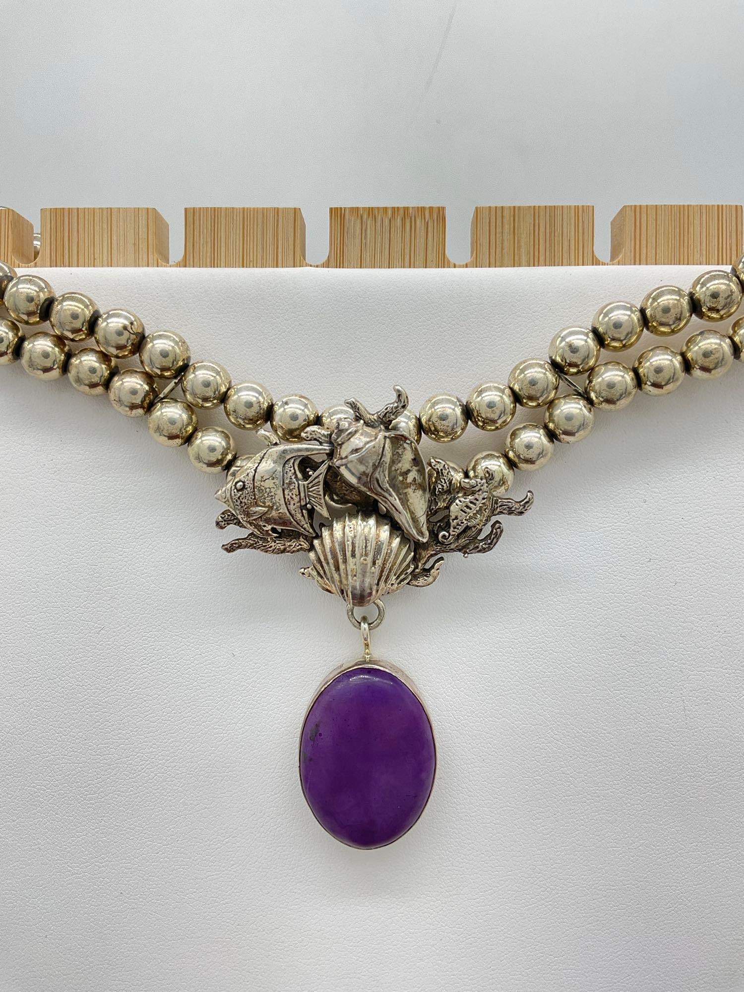 Exquisite 1990 Carol Felley Sterling silver dual strand necklace w/ Aquatic scene pendant: Approx 15" long when laid out. Lovely signed Carol Felley Native American inspired double strand necklace with Sugilite pendant. Approx 81 grams, sugilite stone has what appears to be some light