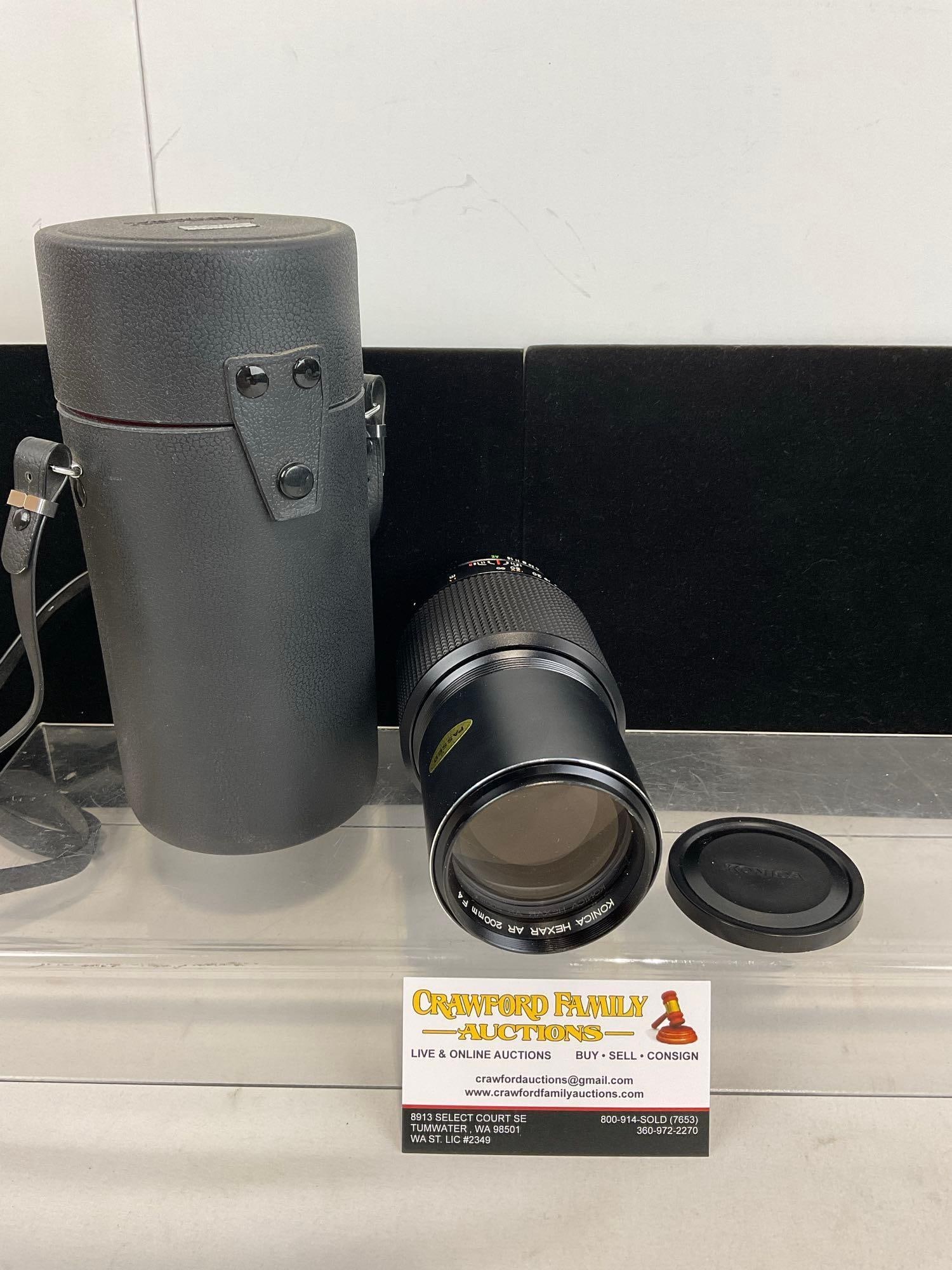 Konica Hexar AR 200mm F4 Lens in leather case, 9h x 5w x 5d inches: Appears to be in good shape. The piece measures approx 9h x 5w x 5d inches. See pics. E-5180 