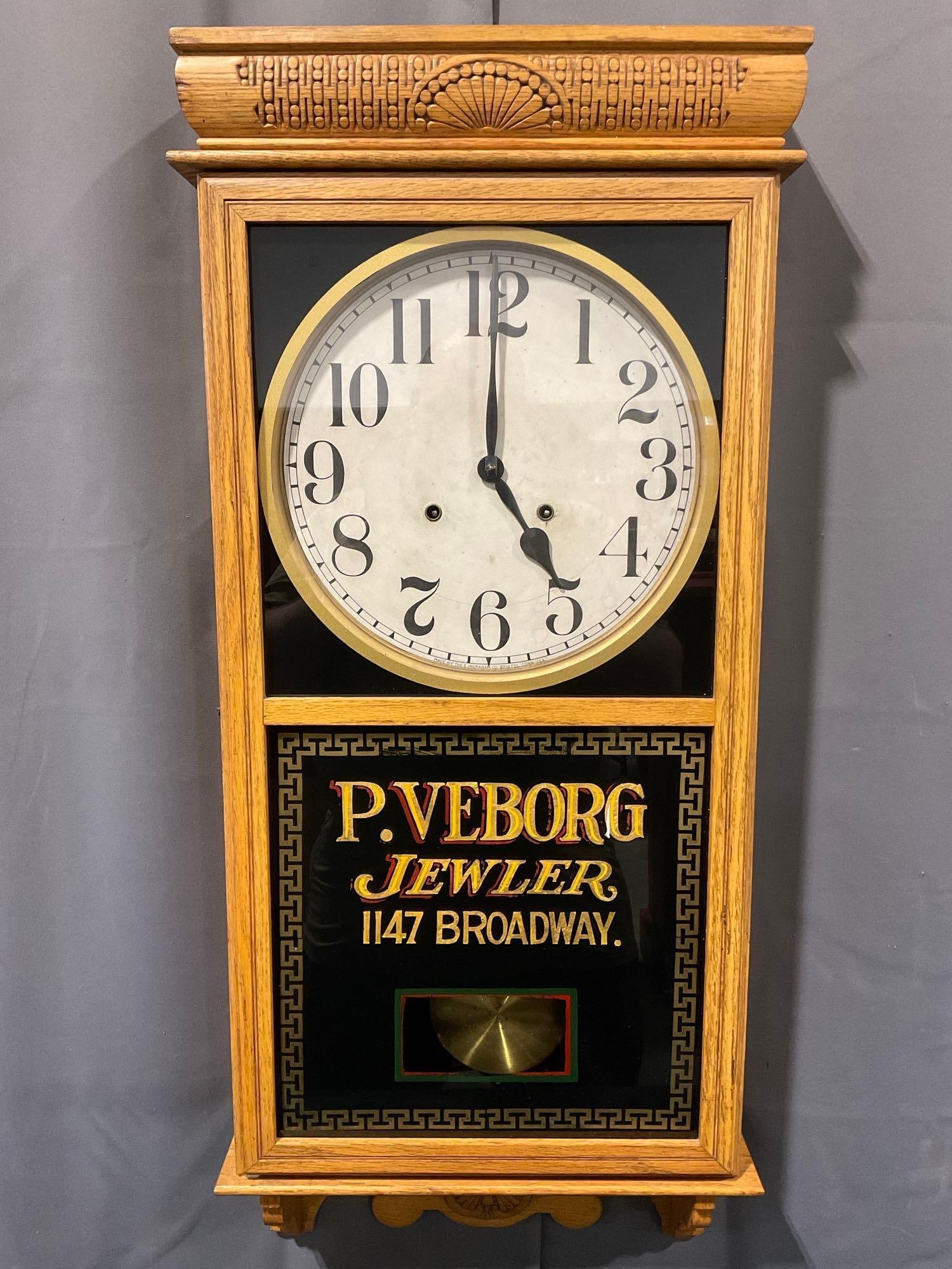 E Ingraham Regulator Wall Time Strike Clock, P. Veborg Jewler on the glass, 37h x 17w x 6d inches: Lovely hand-lettered lower glass panel. Appears to be in good shape. The piece measures approx 37h x 17w x 6d inches. See pics. E-5430 *Oversized shipping may apply* 