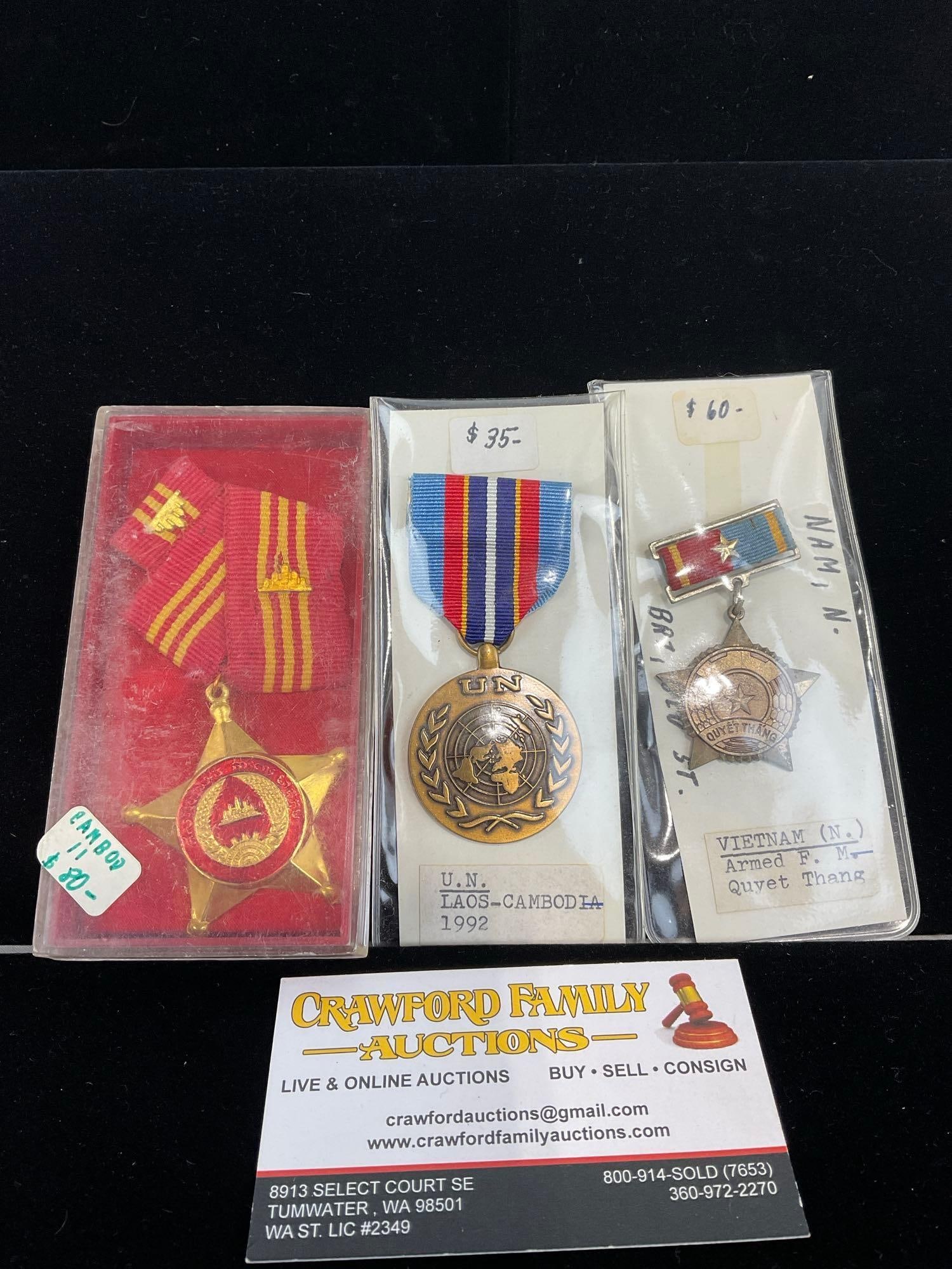 3 Medals, UN Laos-Cambo. 92, North Vietnam Quvet Thang & Kampuchea/Cambodian Red & Gold Medal 1980+: All from a single collection, these are briefly described on the tag and were kept in a display. They measure approx 6h x 3w x 2d inches. See pics. E-5300