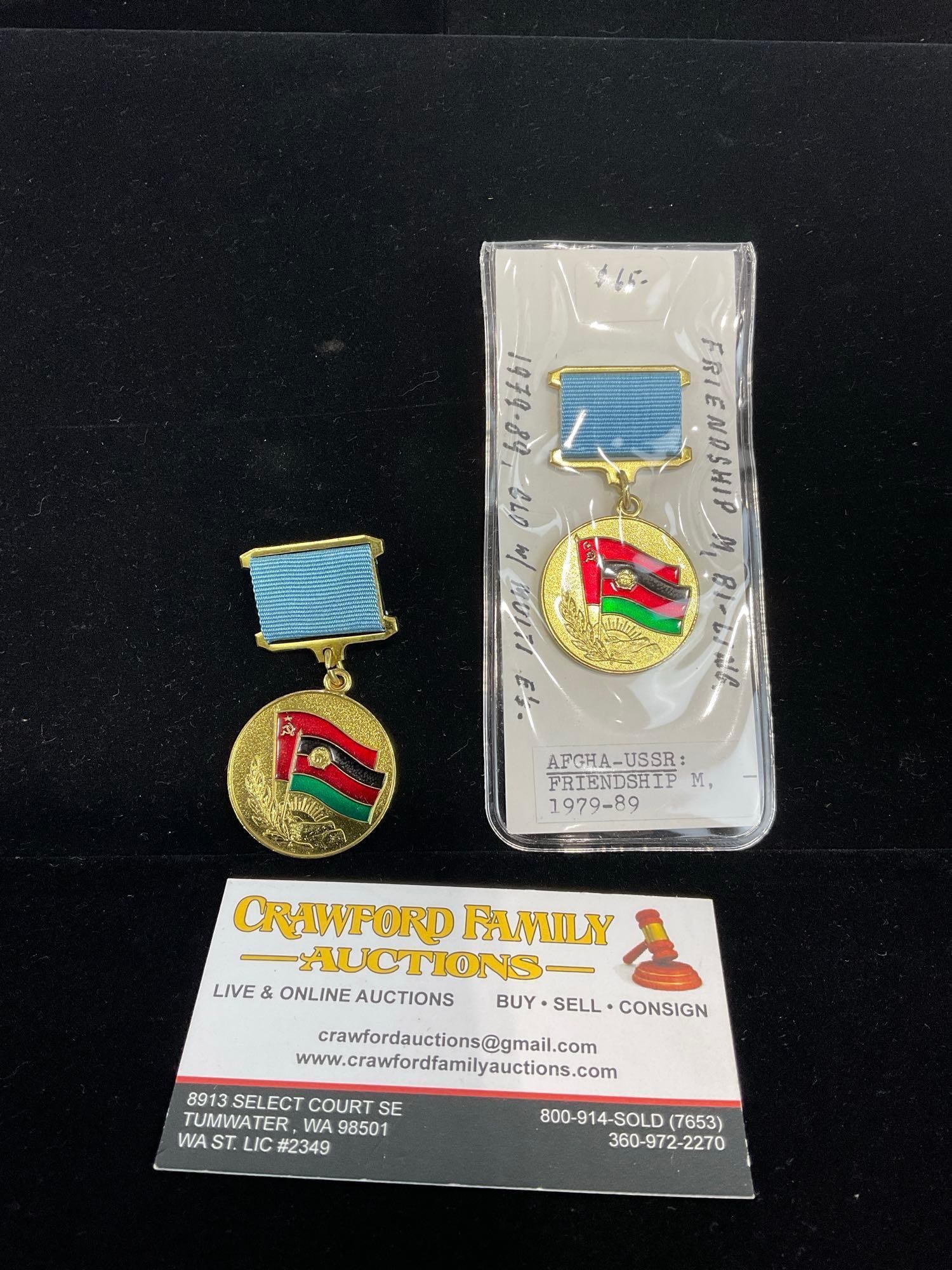 Pair of Afghanistan-USSR Friendship Medals, 1979-89, bronze gilt w/ Enamels: All from a single collection, these are briefly described on the tag and were kept in a display. They measure approx 6h x 3w x 2d inches. See pics. E-5300 