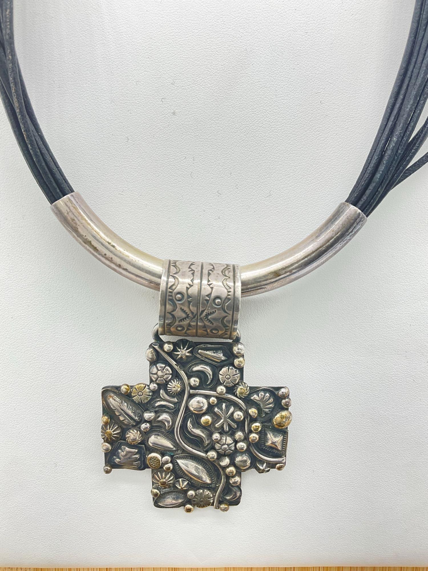 Signed Sterling Silver Choker Statement Necklace w/ Large Cross By Navajo Artist Ronnie Willie: c-5180 This one of a kind piece of art is Made by Famous Navajo Silver Smith Ronnie Willie. The cross is embellished by what appears to be some gold?, and the necklace is Sterling w/ multi strand