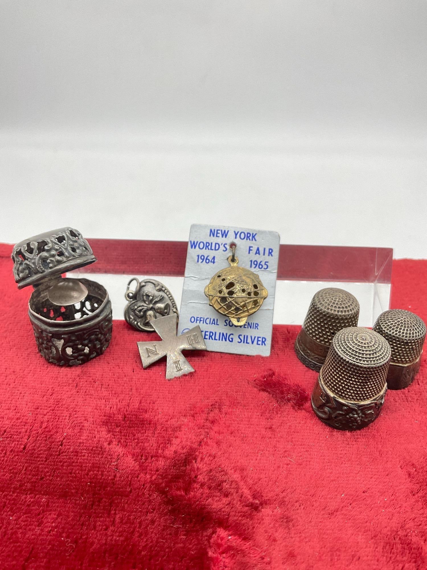 Set Antique Sterling 3x sewing thimbles w/ Thimble Holder + Antique Heart pendant, cross & Globe: C-5180 All items are sterling Approx 28 Grams 1886 Masltes Cross ("in His Name ) Order of the Kings Daughters & Son) Globe is 1964-65 New York worlds Fair Souvenir 
