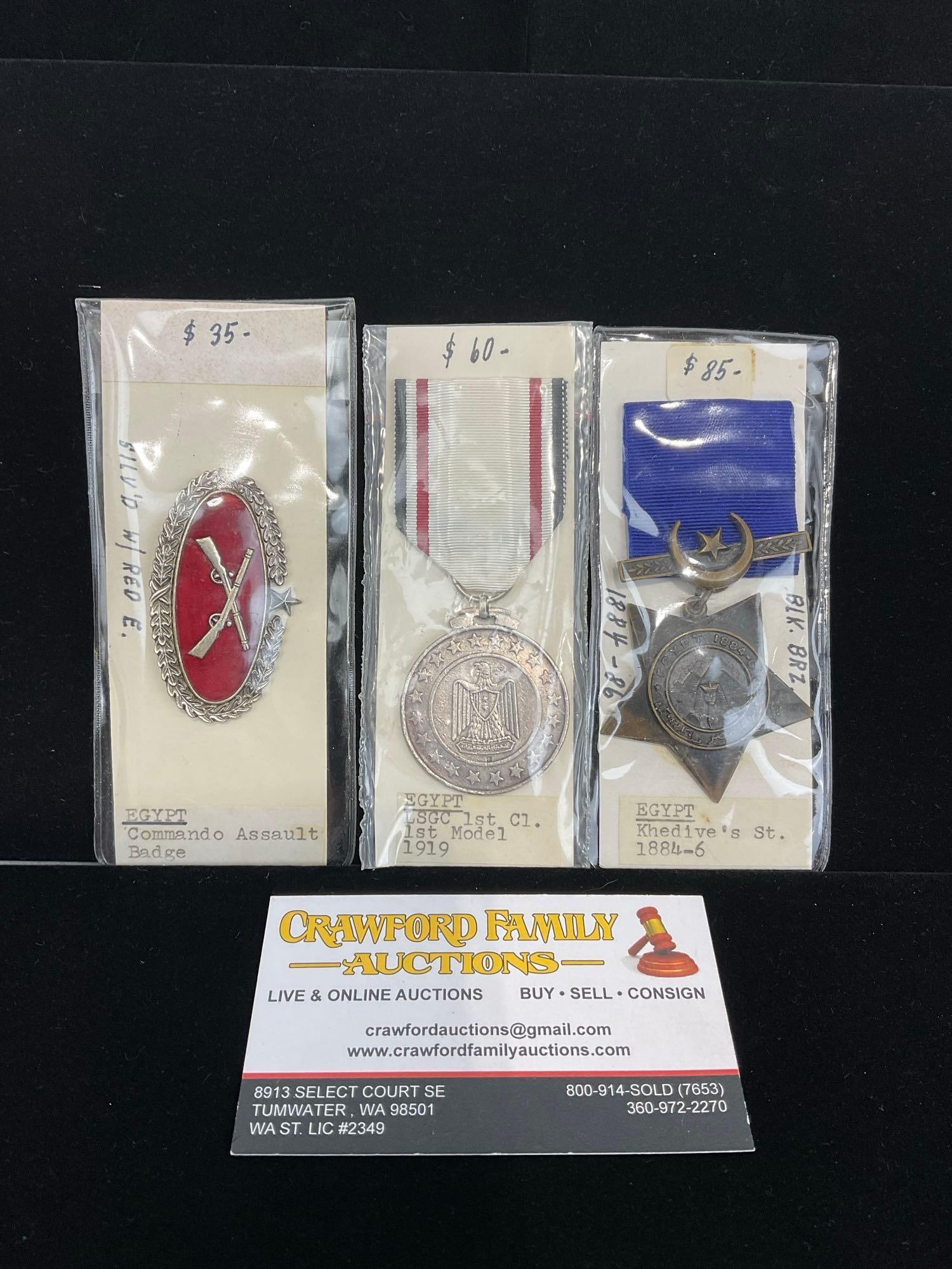 2 Egyptian Medals & Pin, Commando Assault Badge, LSGC 1st Cl 1st model 1919 & Khedives St 1884-1886: All from a single collection, these are briefly described on the tag and were kept in a display. They measure approx 6h x 3w x 2d inches. See pics. E-5300 