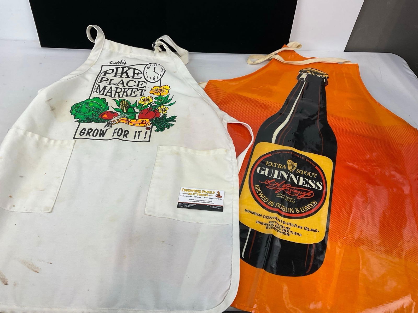 2 Vintage Aprons, Seattles Pike Place Market, White & Extra Stout Guinness, Orange by Sari Fabrics: Appears to be in good shape. The piece measures approx 10h x 6w x 4d inches. See pics. E-4880 