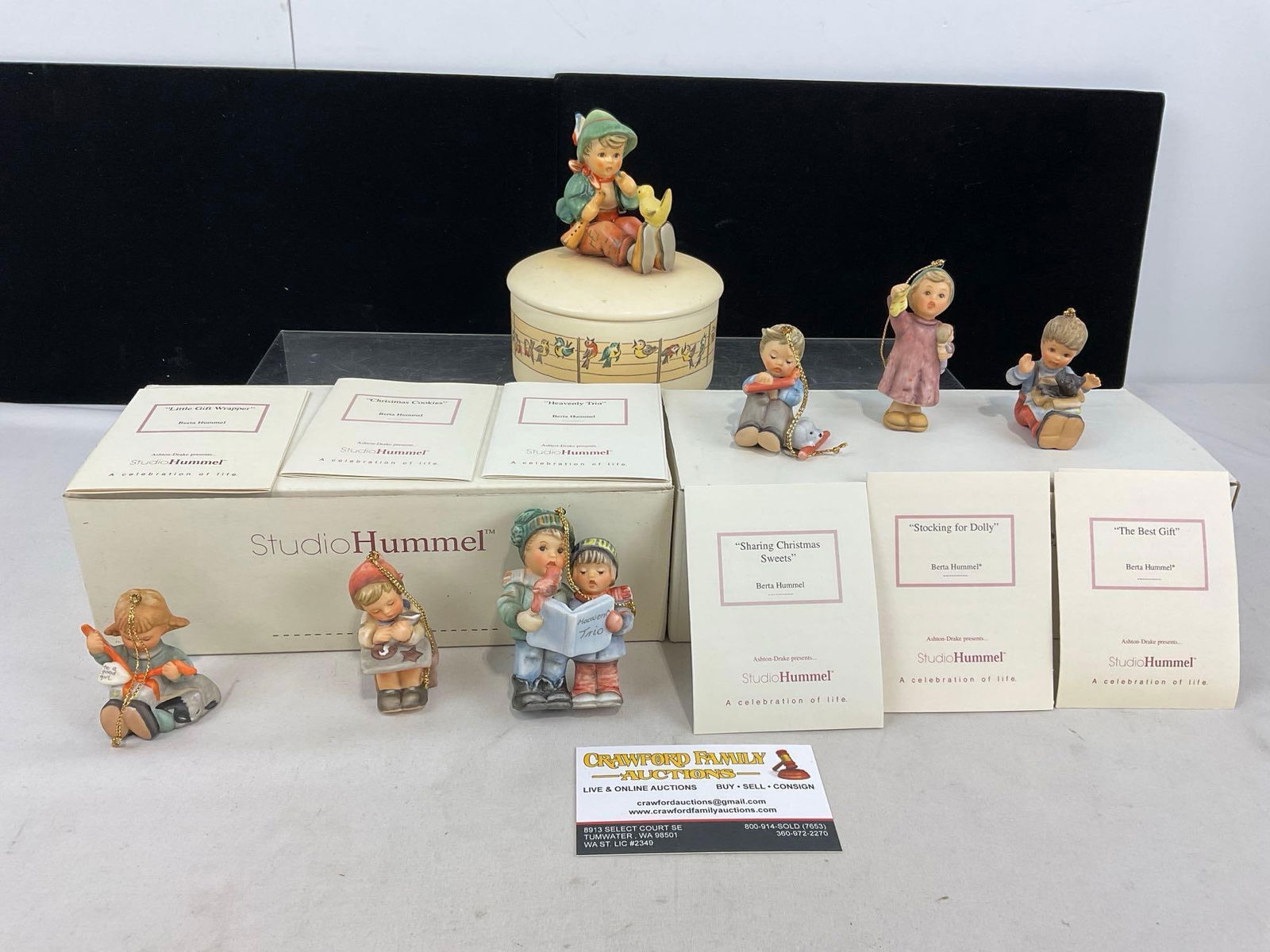 Hummel Music Box & 2 3 Packs of small Studio Hummel Figures, Ornaments, w/ box & paperwork: Includes: Sharing Christmas Sweets, Stocking for Dolly, The Best Gift, Heavenly Trio, Christmas Cookies, Little Gift Wrapper. Appears to be in good shape. The piece measures approx 10h x 10w x 9d inch