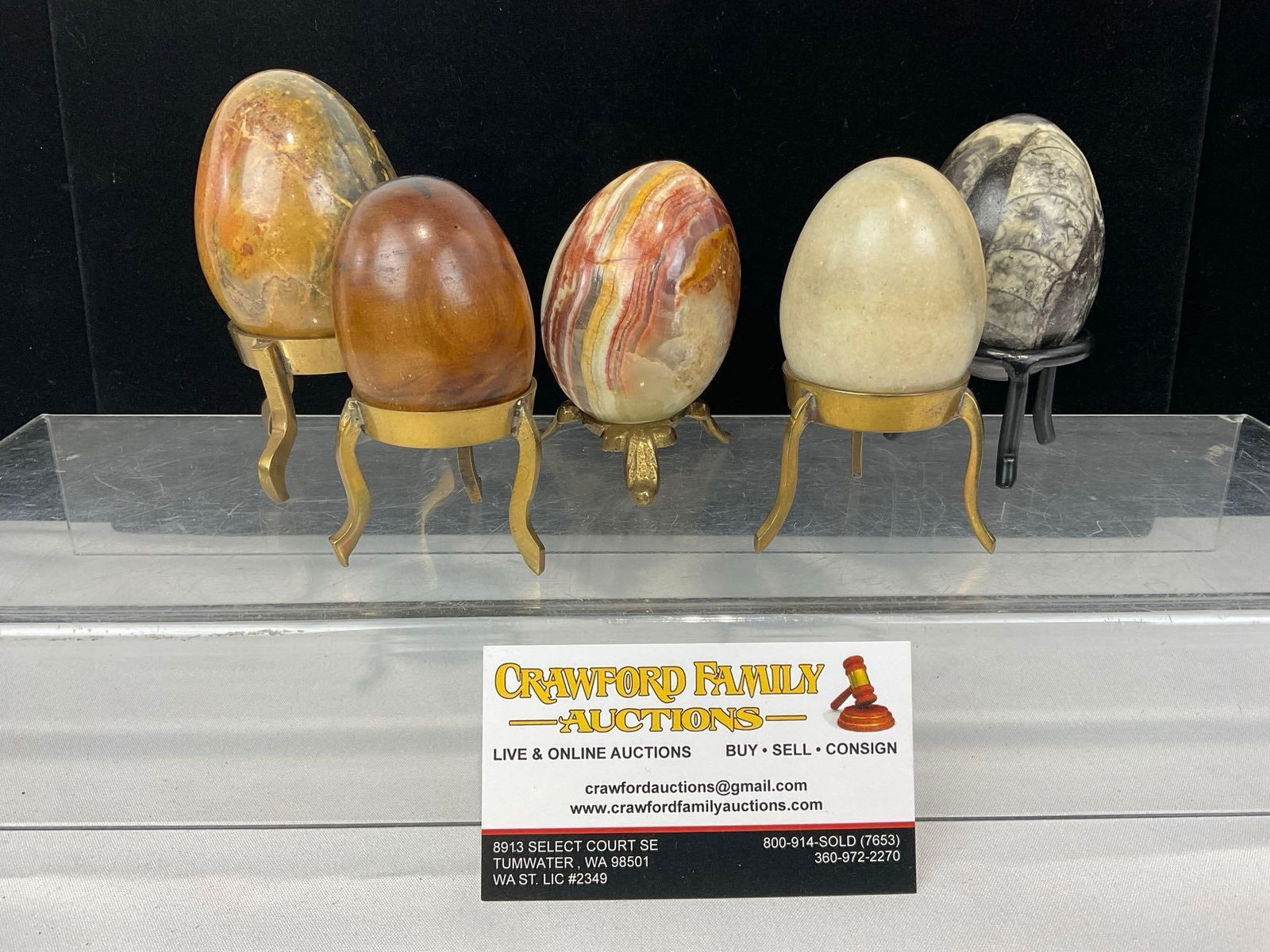 5 Polished Carved Egg Pieces, 3 Stone, 1 Wooden & 1 Orthoceras Fossil, w/ 5 Stands: Appears to be in good shape. The pieces together measures approx 4h x 11w x 7d inches. See pics. E-5360 