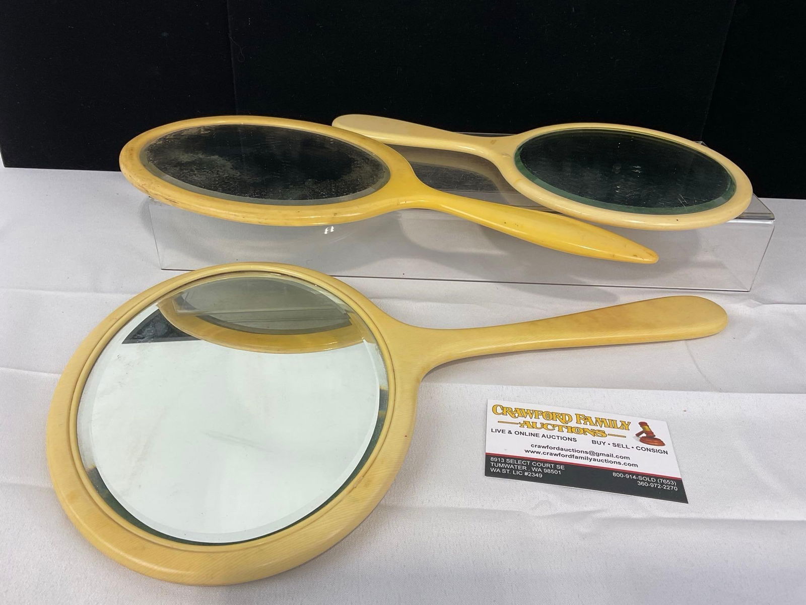 3 20th Century Vanity Mirrors, Bakelite/Celluloid in off-white color, beveled Glass: Appears to be in good shape. The piece measures approx 16h x 10w x 3d inches. See pics. E-5440