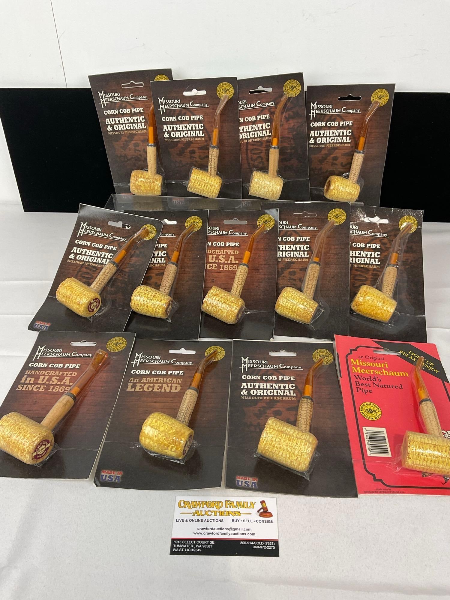 13 Missouri Meerschaum Co Corn Cob Pipes, in packaging, Bent Stems: Similar to the nearby lots. Appears to be in good shape. The piece measures approx 8h x 11w x 9d inches. See pics. E-5430 