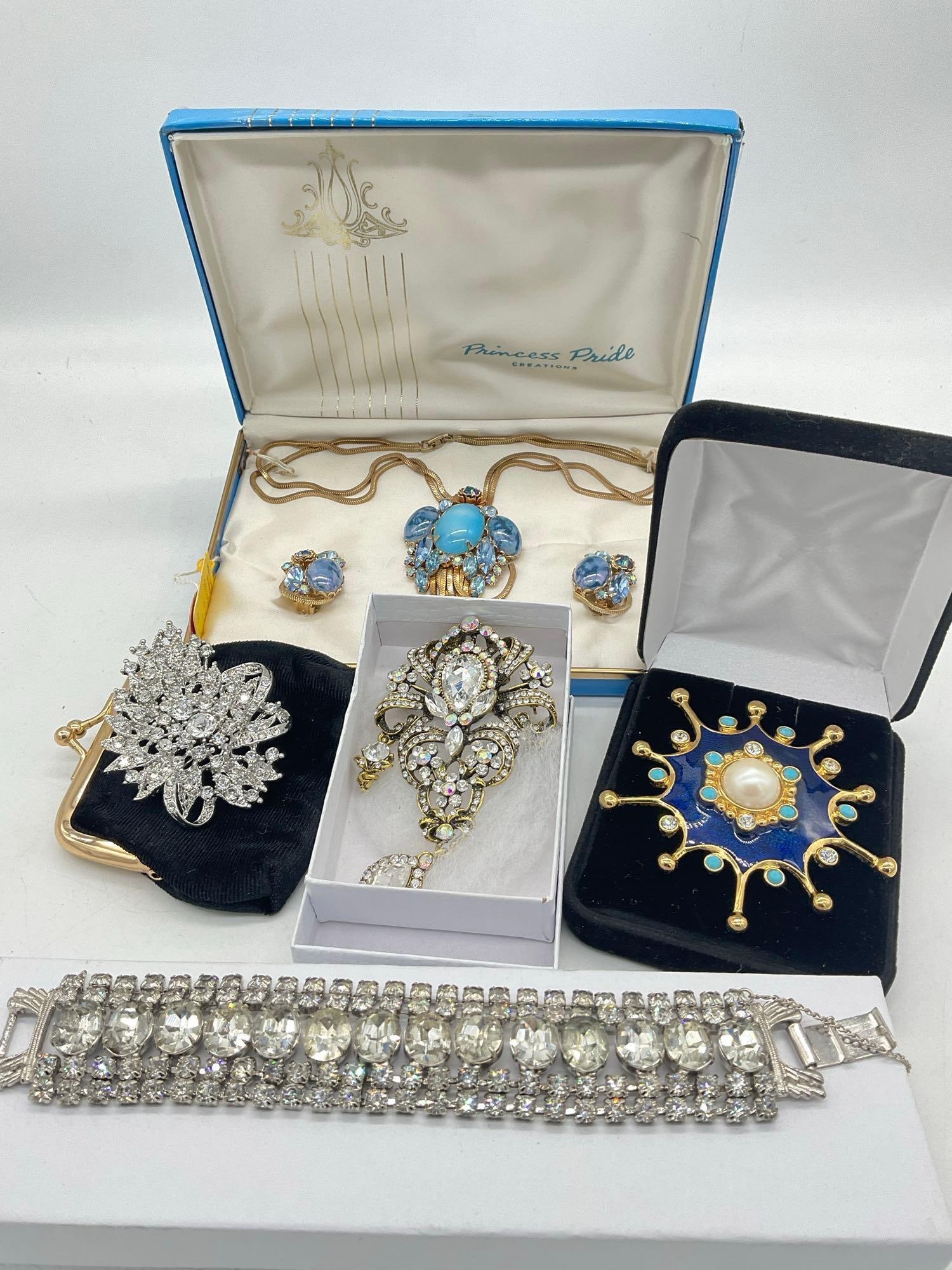 Collection of Vintage Mid Century Fashion Jewelry Brooches, Bracelet, Necklace & earrings 1x signed: C-5280 3 x brooches and small black coon purse 1 brooch is a Signed MC Gold toned and blue Enamel star Snow flake w/ crystals & a faux pearl center setting. Rhinestone