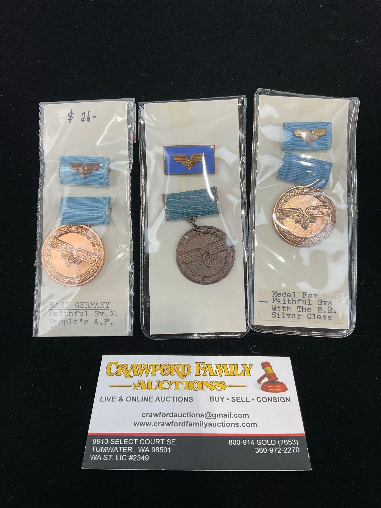 3 GDR East German Medals, Faithful Service Medal, Peoples Air Force & Railroad: All from a single collection, these are briefly described on the tag and were kept in a display. They measure approx 6h x 3w x 2d inches. See pics. E-5300 