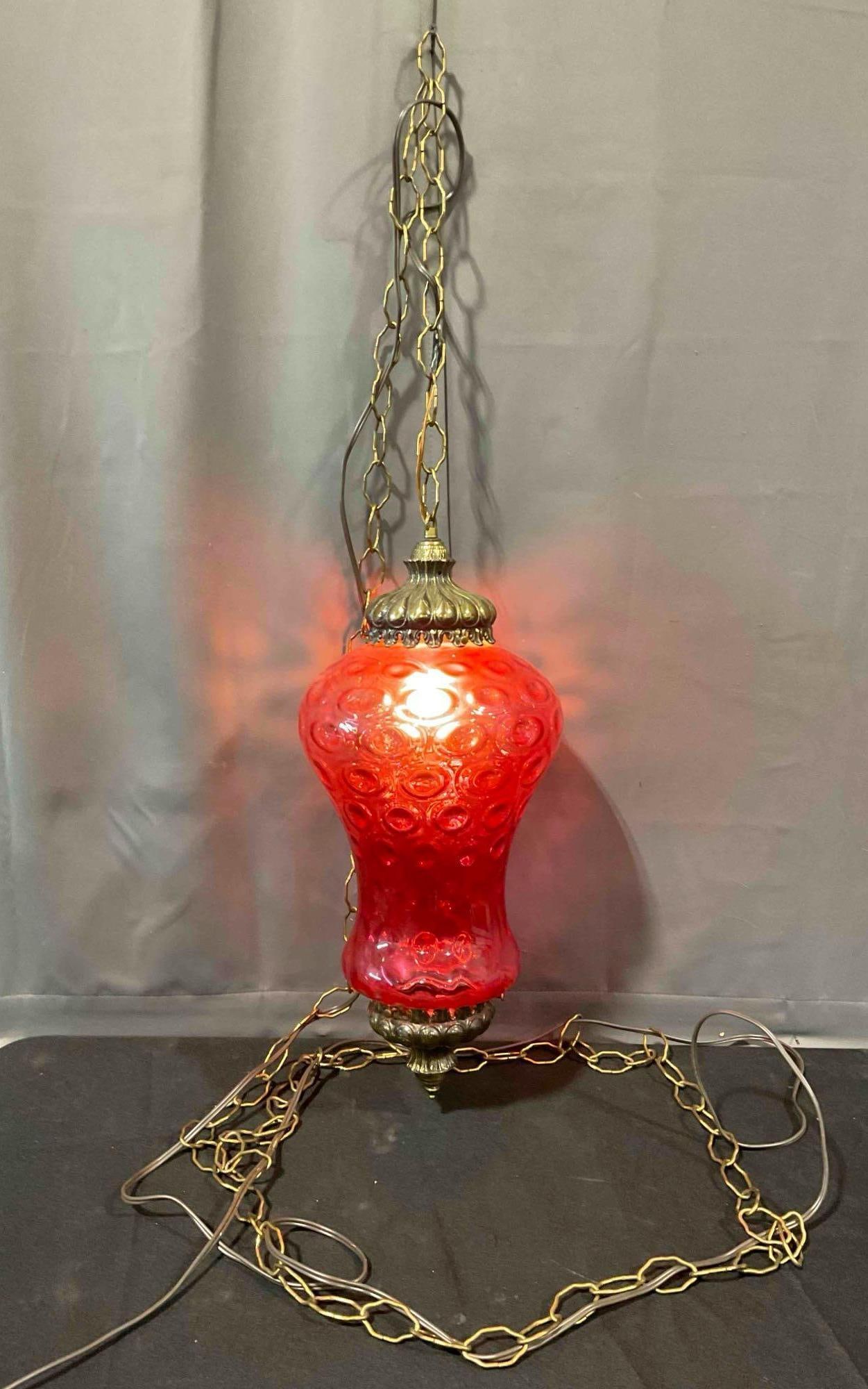Vintage MCM Hanging Swag Lamp w/ Textured Cranberry Red Glass Shade. Tested, Works.: Vintage MCM Hanging Swag Lamp w/ Textured Cranberry Red Glass Shade. Tested, Works, flickers and might need new bulb. Matches lot #75. Minor wear indicative of age, one tiny chip in glass, condition i