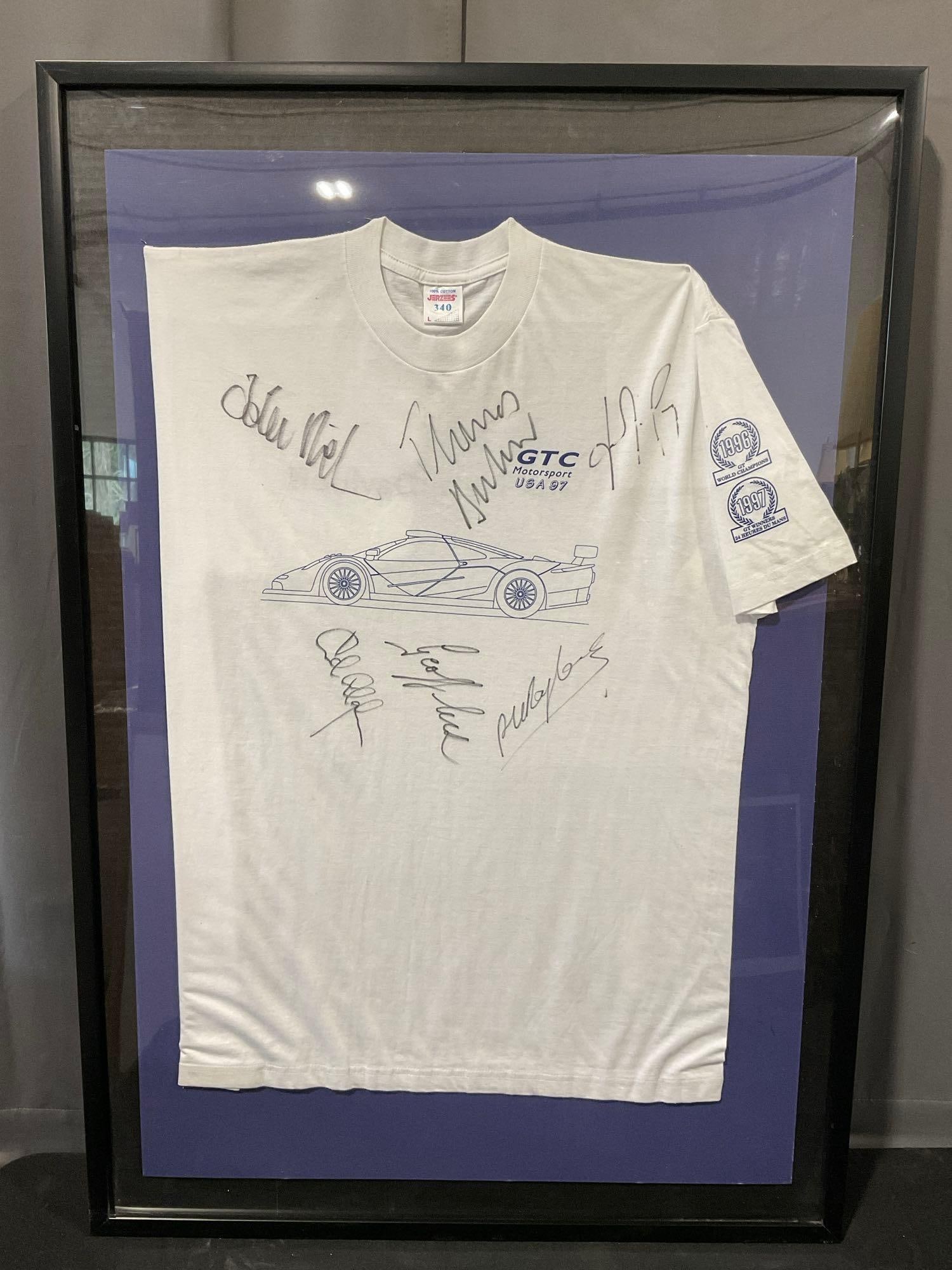 Framed GTC Motorsport USA 1997 Tee Shirt Signed by Drivers, 42h x 29w inches: Signed by drivers such as John Niel, Geoff Lister, Thomas..., & more. Appears to be in good shape. The piece measures approx 42h x 29w x 3d inches. See pics. E-5420 *Freight Required if