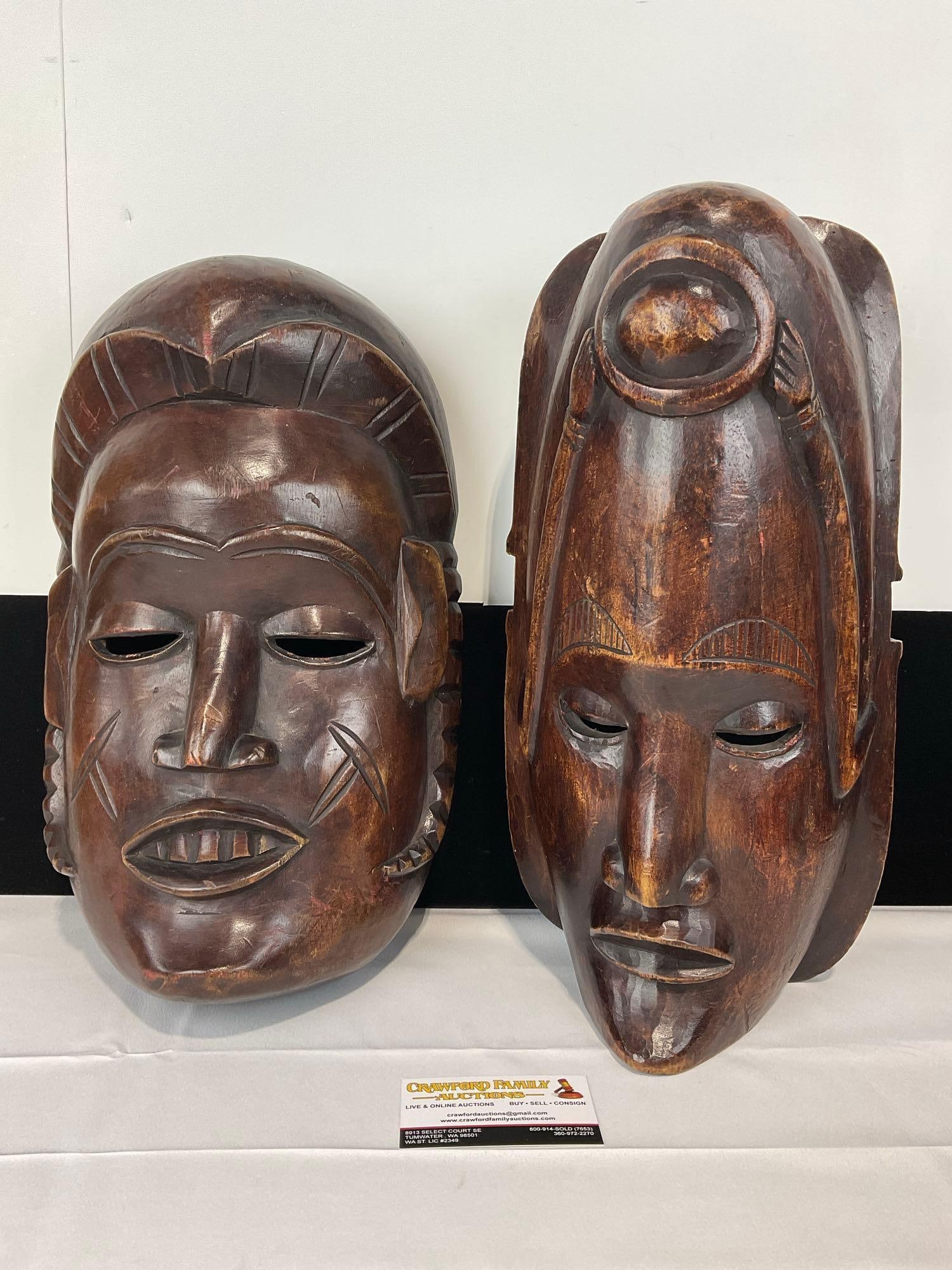 Pair of Carved Wooden African Masks, Dark Tone Wood, Wall hangings, 16h x 8w x 10d inches: Appears to be in good shape. The piece measures approx 16h x 8w x 10d inches. See pics. E-5540