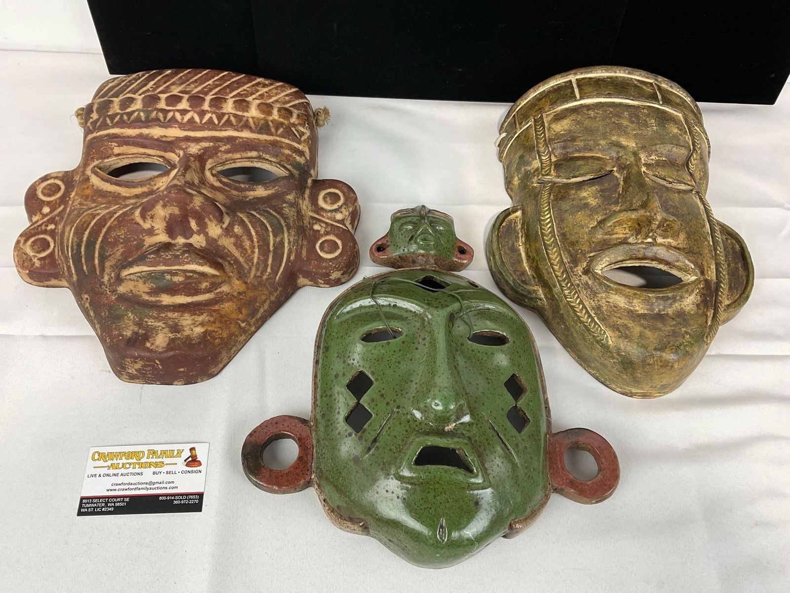 Three Pottery Masks, Mayan style, Red, Green & Yellow Glazed, 14h x 16w x 11d inches: Appears to be in good shape, one has been repaired previously. The piece measures approx 14h x 16w x 11d inches. See pics. E-5540 
