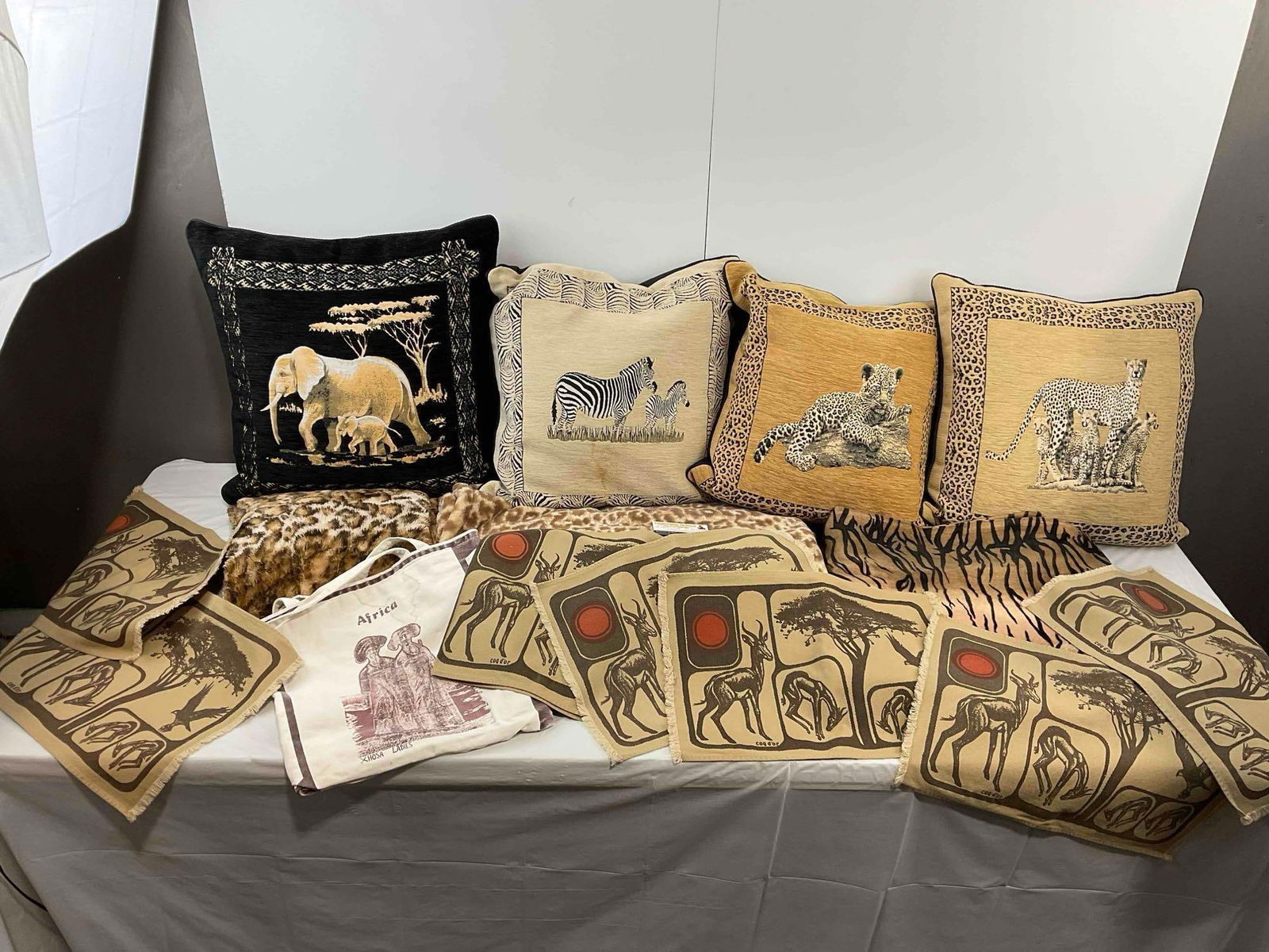 14 pcs African Themed Textile & Pillow Collection, incl. 2x Animal Print Blankets & More! See pics.: 14 pcs African Themed Textile & Pillow Collection, incl. 2x Animal Print Blankets & More! Also includes 6 place mats and canvas bag. Minor stains, condition is otherwise very good. Measures