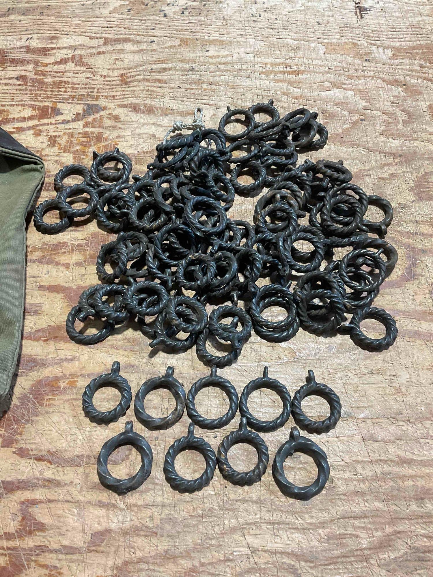 Collection of 50+ Iron, Hand Forged, Spiral Twisted Ring Door Knockers: Approximately 12" x 5" x 9" items are in fair condition with mild patina and light oxidation consistent with their age. Comes with a Seattle First National Bank storage bag. V-5360 *Oversized shi