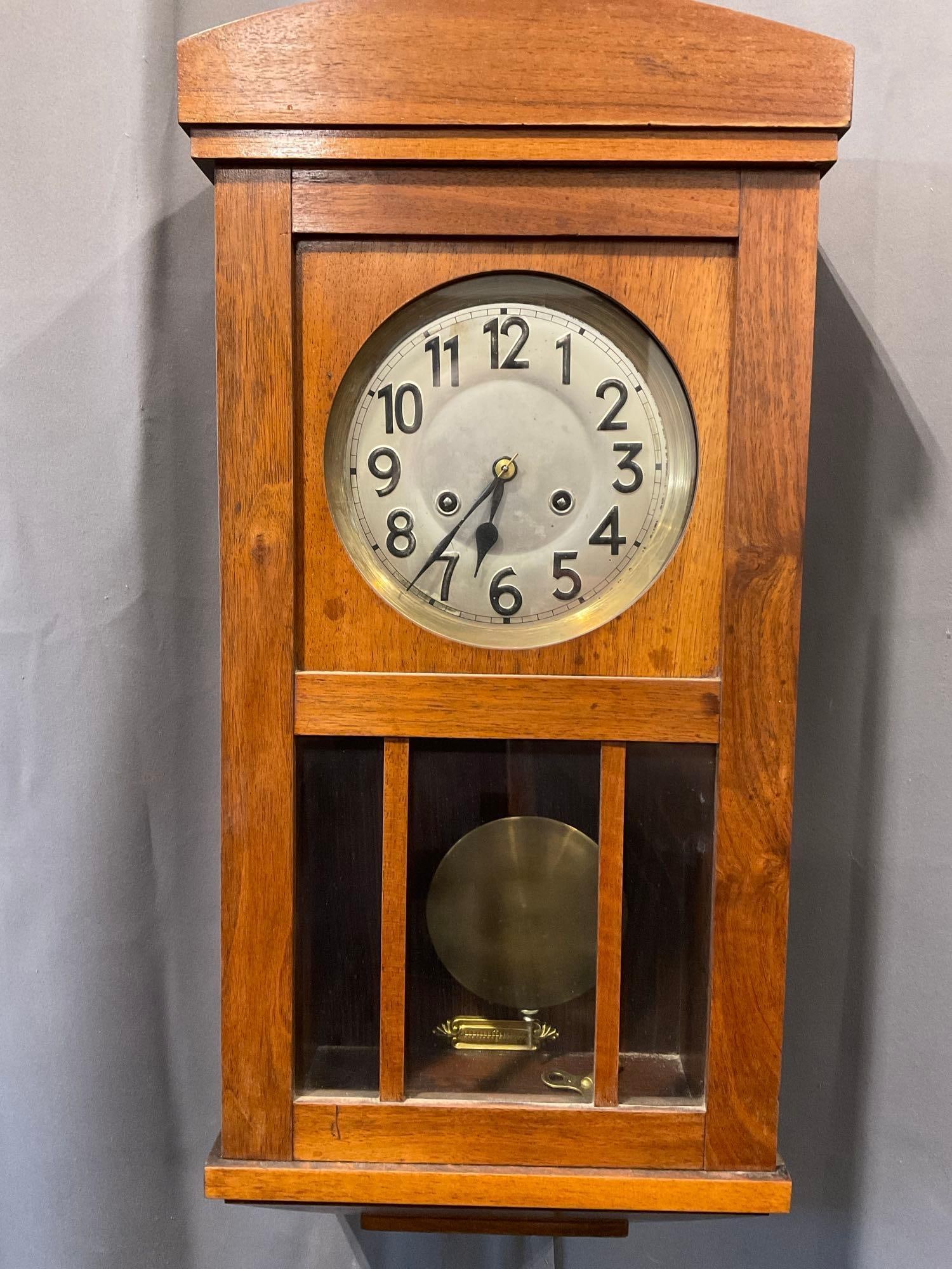 Early 20th Century German Wall Clock, Time Strike, w/silver tone face, 25h x 13w x 7d inches: All comes from the same collection. Appears to be in good shape. The piece measures approx 25h x 13w x 7d inches. See pics. E-5580 