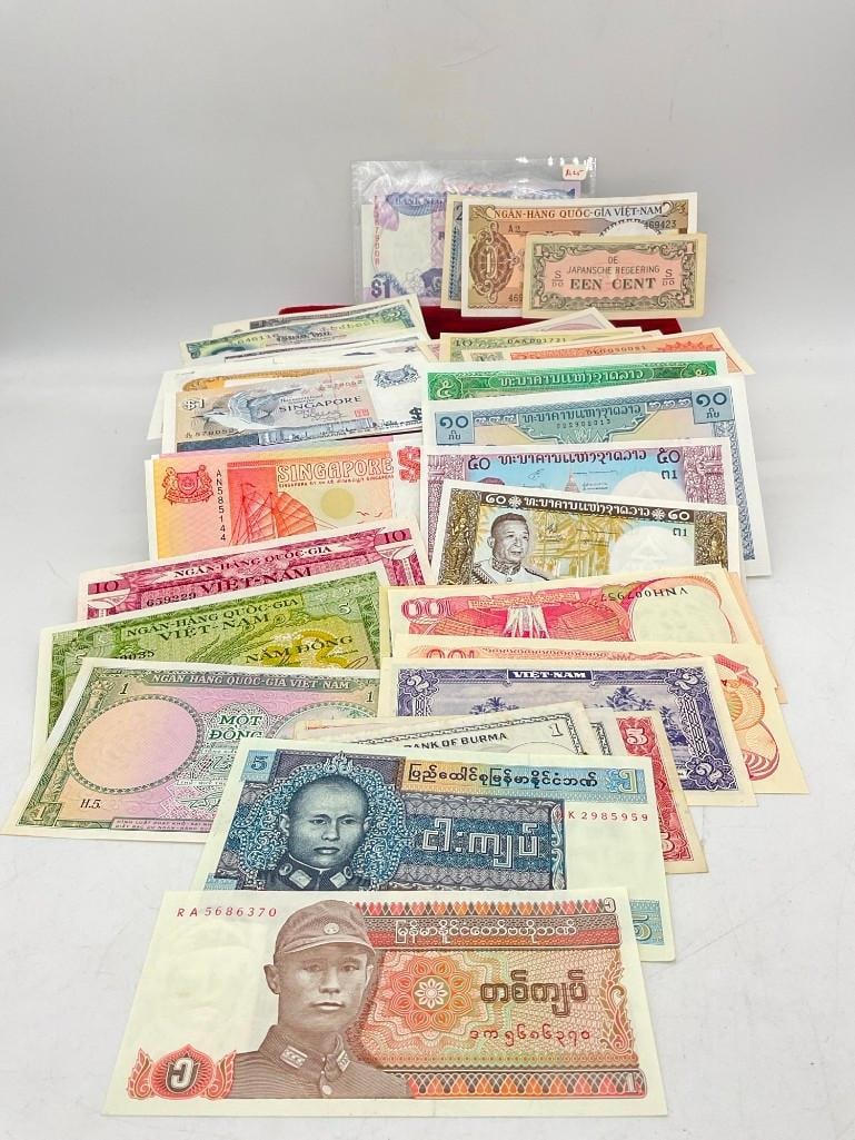 40 + Uncirculated Foreign Currency mostly 1940-1960's Indonesia, Thailand, Burma , Cambodia Plus: C-414 Includes Vietnam, Singapore, japan See pics 