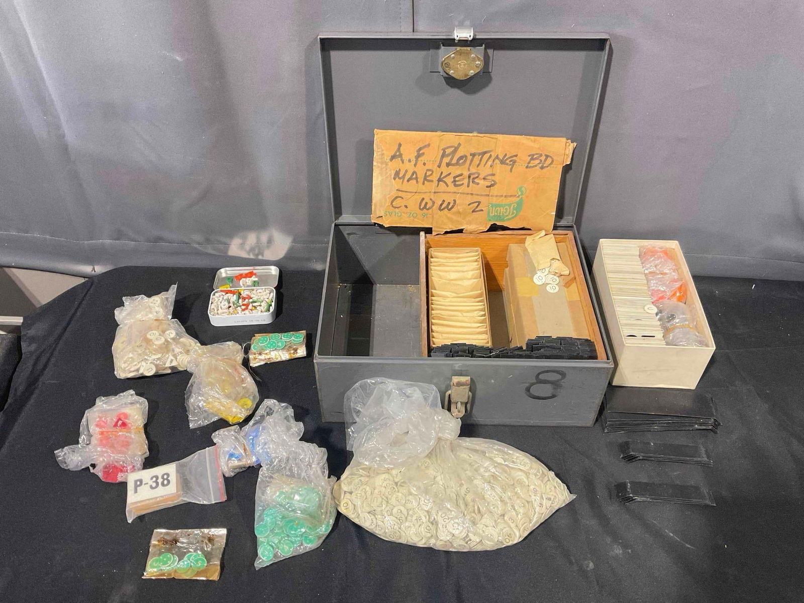 Uncounted U.S. Air Force Plotting Board Markers Collection Circa World War II in Metal Case. See: Uncounted U.S. Air Force Plotting Board Markers Collection Circa World War II in Metal Case. Large collection, multiple uncounted bags and still sealed envelopes. Pieces have minor wear indicative of