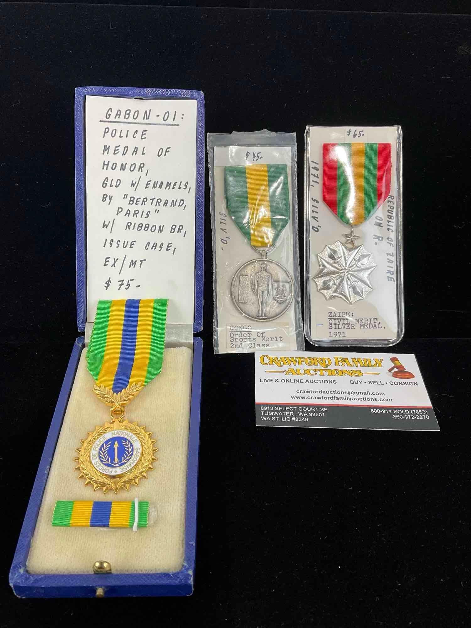 3 Medals, Gabon Police Medal of Honor, Congo Order of Sports Merit 2nd cl & Zaire Civil Merit Sil...: All from a single collection, these are briefly described on the tag and were kept in a display. They measure approx 6h x 3w x 2d inches. See pics. E-5300