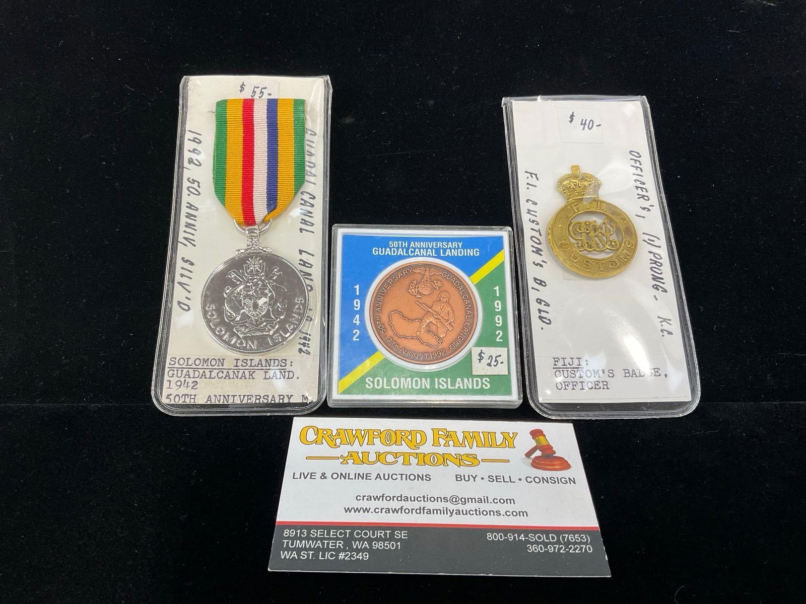 Solomon Islands Guadalcanal Landing Coin & Medal & Fijian Customs Officer Badge: All from a single collection, these are briefly described on the tag and were kept in a display. They measure approx 6h x 3w x 2d inches. See pics. E-5300 