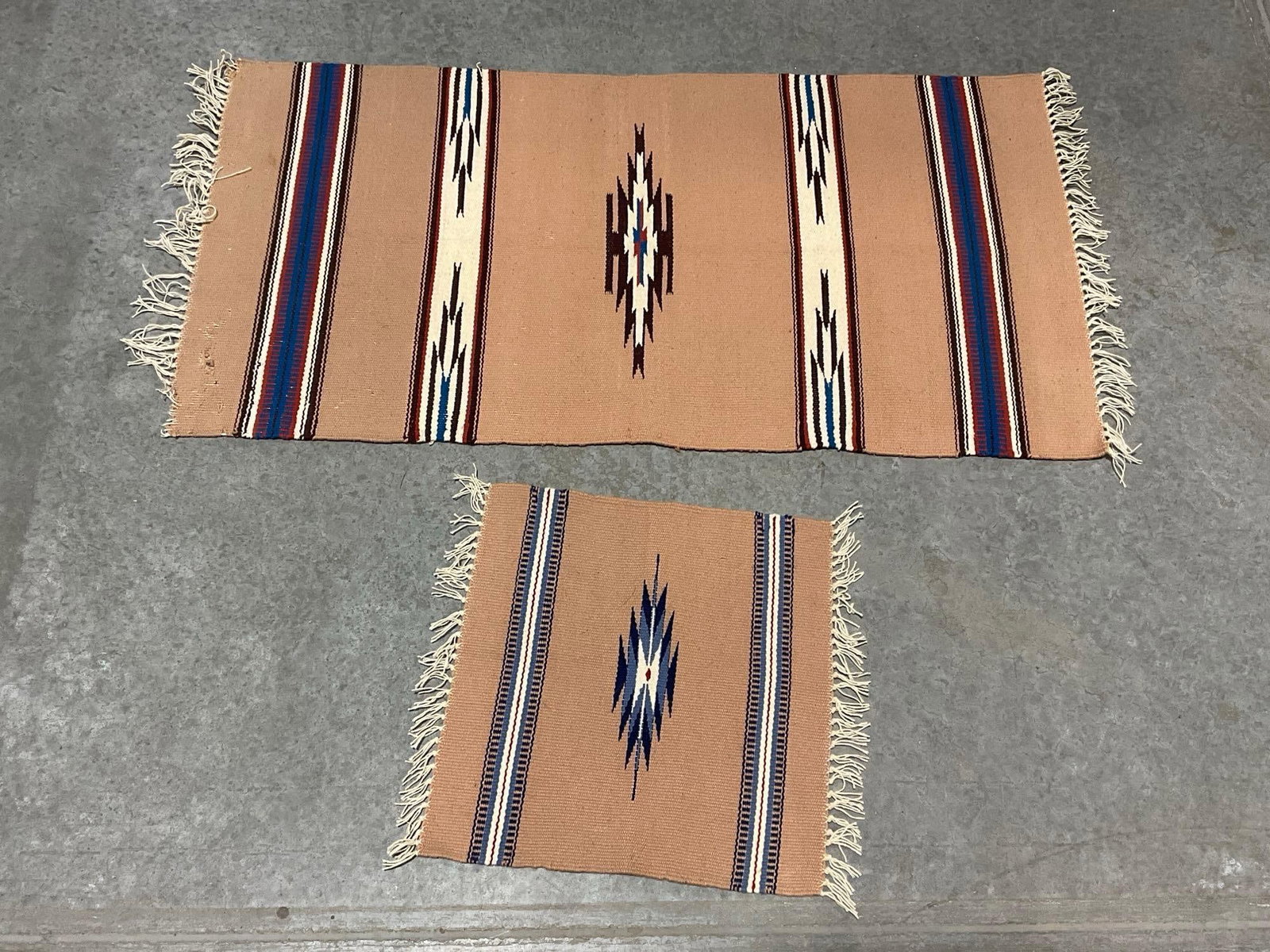 Pair of Small Navajo Handmade Rugs, 44 x 22 inches, Pale Taupe, Red/Blue/White Details: Appears to be in good shape. Larger rug measures 43" x 20.5", smaller rug measures 16" x 14.5". See pics. E-5630 