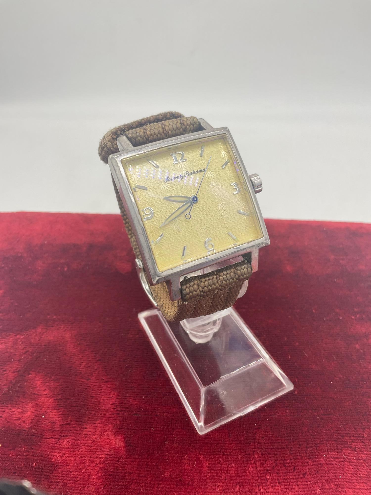 Vintage Tommy Bahama Swiss Men's wrist watch with .925 Sterling back TB 1013: C-5010 Not running sold as is band in fair condition watch is fair to good condition cosmetically 