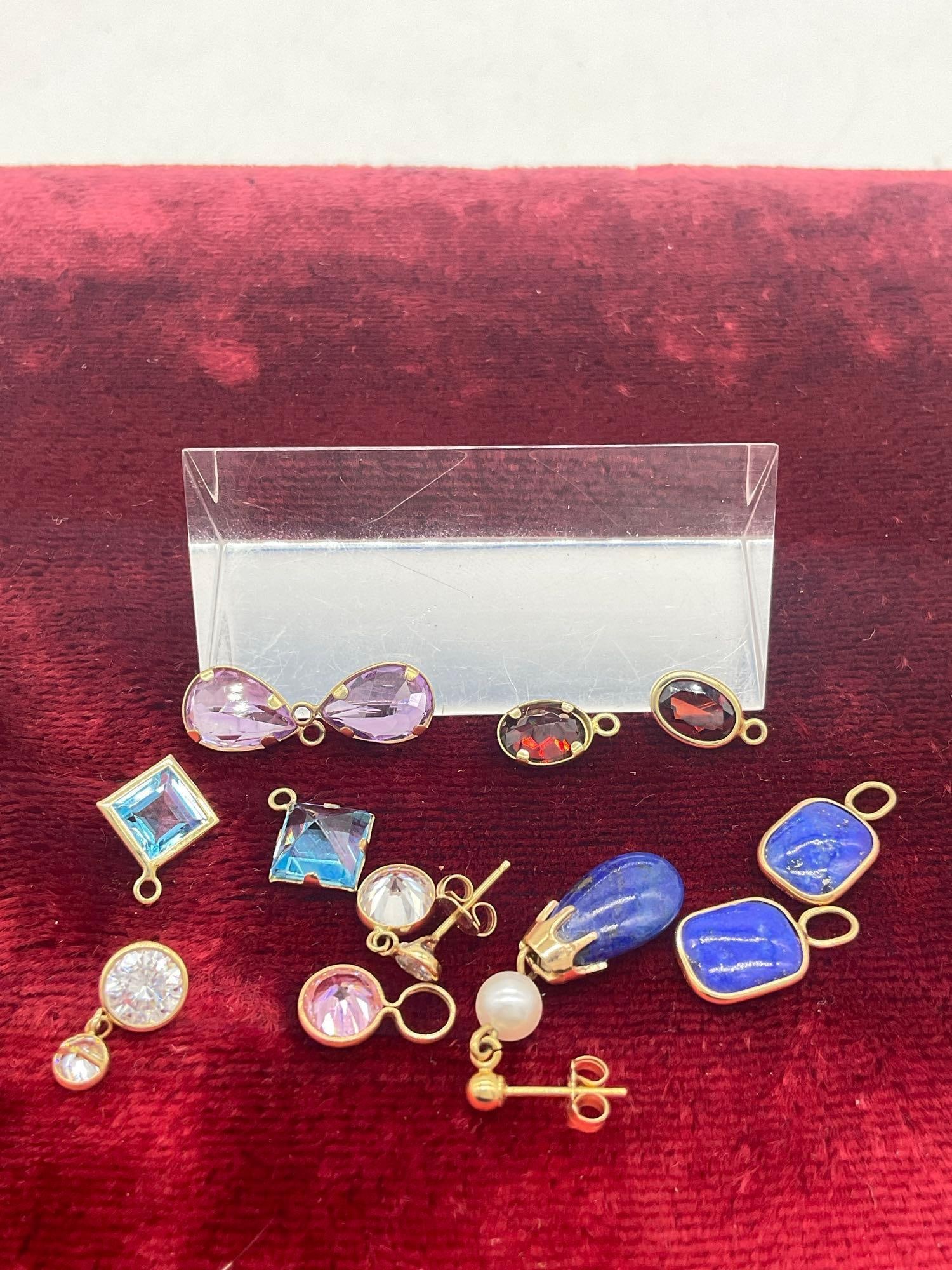 9 x 14K gold small pendants w/ various stones & 1 set 14k gold CZ earrings ,1 single lapis, pearl: c-414 The single earring is appears to be lapis and pearl , the set of 14K cz earrings ,one is missing post Total Weight 7.12 grams 