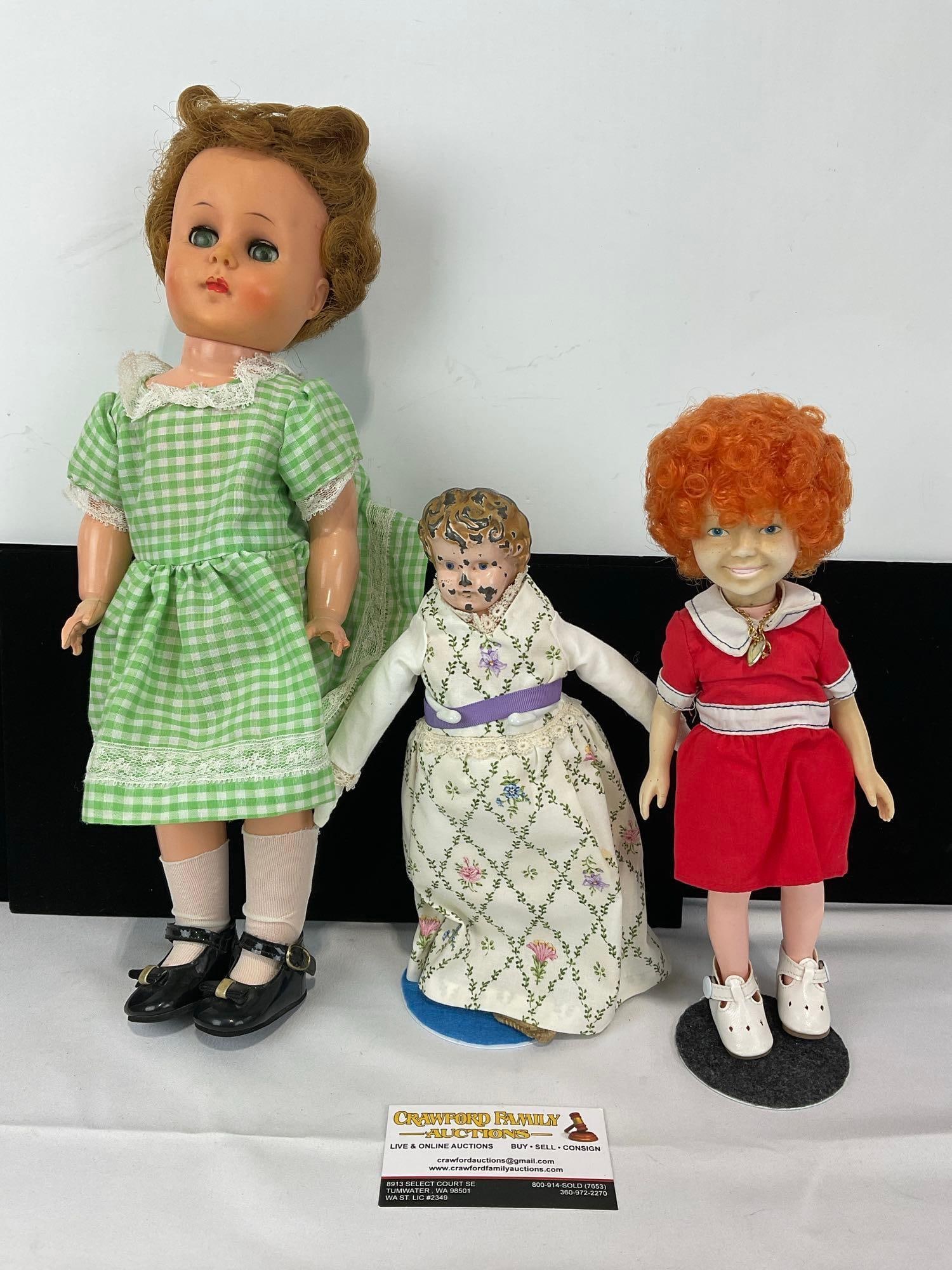Antique German Metal Head Doll, Knickerbocker Toy Co Annie & Unmarked Doll: Appears to be in fair to good shape, missing some finish on the German Metal doll, and the leg has come off of the green dress one. The piece measures approx 14h x 7w x 7d inches. See pics. E-5430