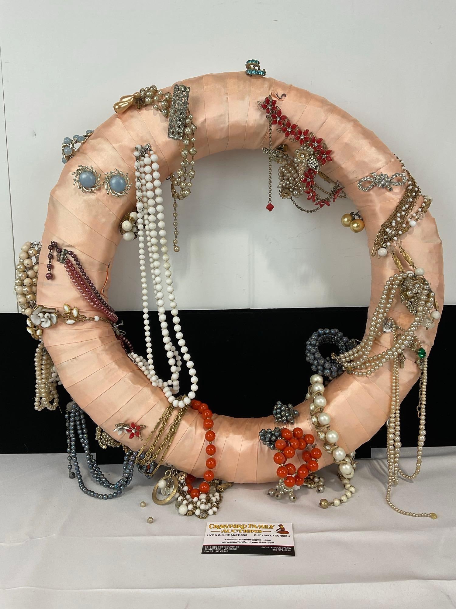 Vintage Costume Jewelry on Pink Stain Fabric Wrapped Wreath, Earrings, Necklaces, & more, 4x20x20...: Appears to be in fair to good shape. The piece measures approx 4h x 20w x 20d inches. See pics. E-5430