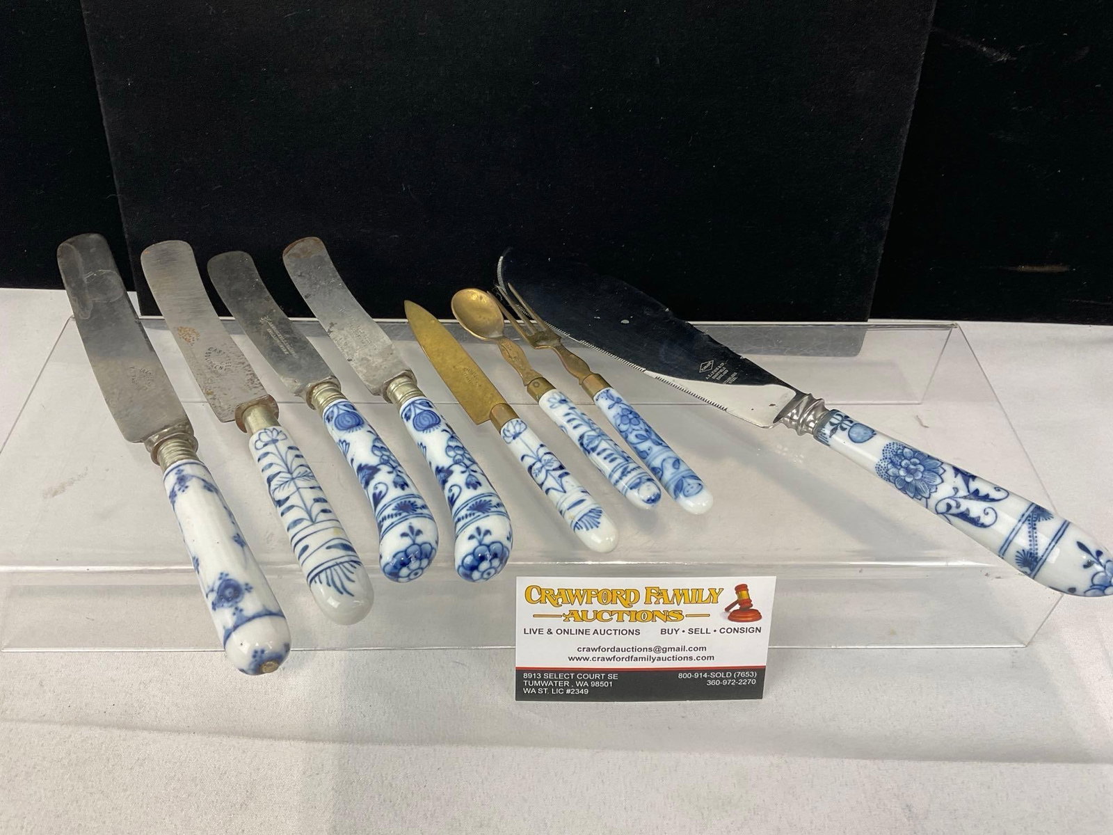 8 Blue/White Porcelain Handled Knives, Spoon, Fork & Serving Knife, Raadvad, Henckels, & more: Appears to be in good shape. The piece measures approx 3h x 10w x 6d inches. See pics. E-5520 