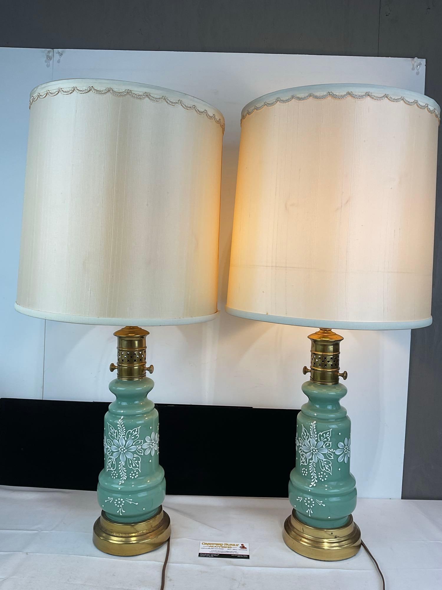 Pair of Handpainted White Floral Design Jade Glass Lamps, Brass w/White Shades, both tested/working: no bulbs included. Appears to be in good shape. The piece measures approx 22h x 14w x 14d inches. See pics. E-5850