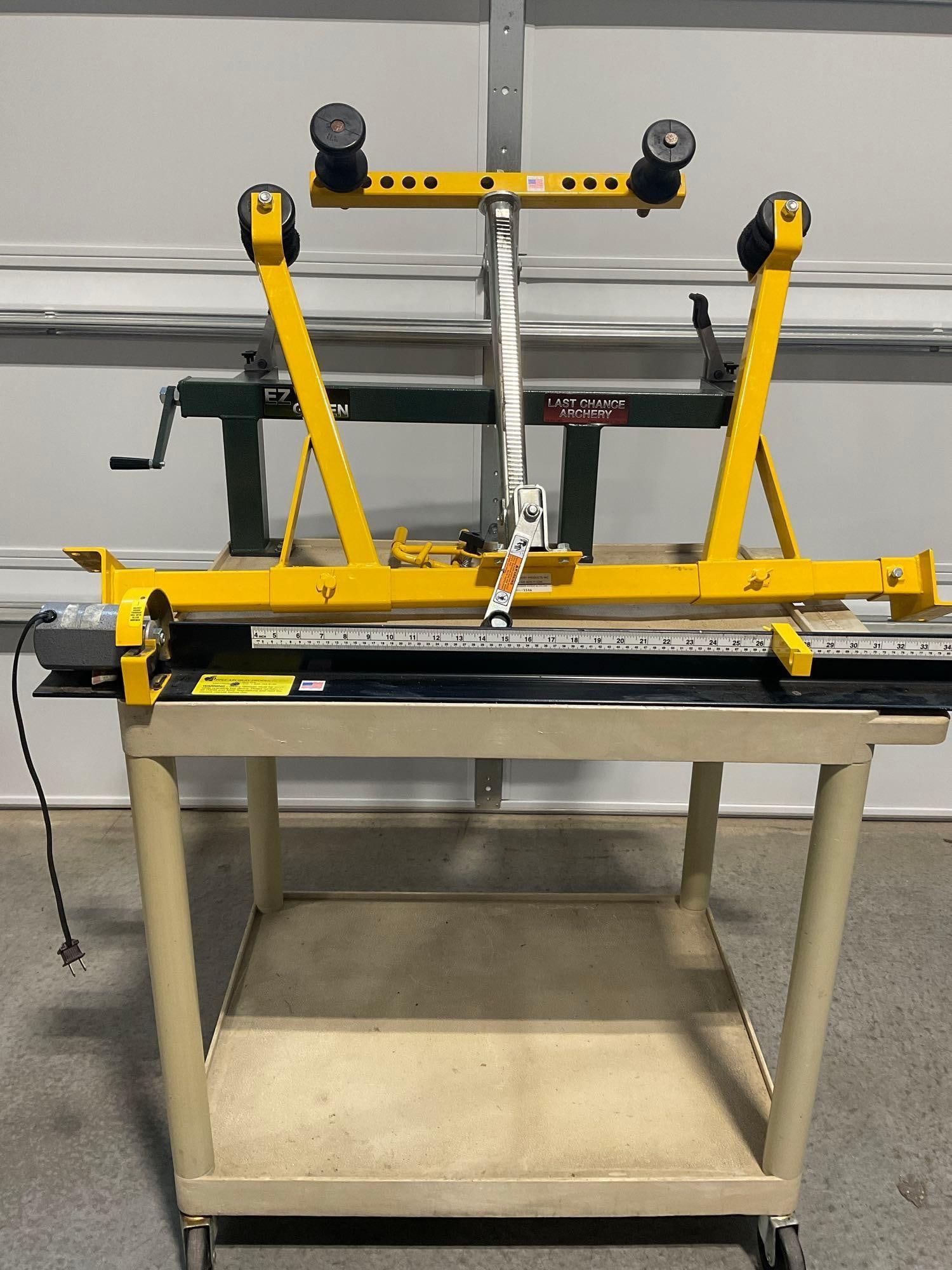 Apple Archery Bow Press & EZ Green Last Chance Archery on Mobile Cart: Appears to be in used good shape. The piece measures approx 48h x 45w x 32d inches. See pics. E-5600 *Freight Required if shipped, Buyer Arranged/Responsibility*
