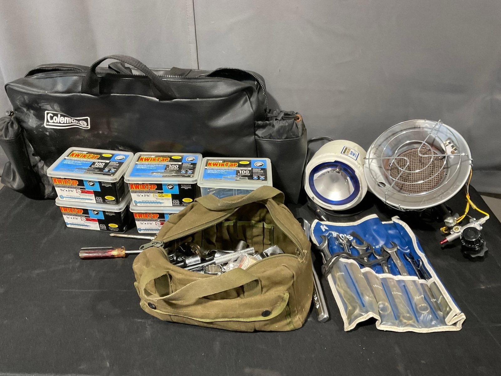 6 boxes of Kwik-Tap Screws, Coleman Bag, Set of Socket Wrenches & Wrenches, Light & Gas Heater Head: Appears to be in good shape. The piece measures approx 18h x 28w x 12d inches. See pics. E-5600