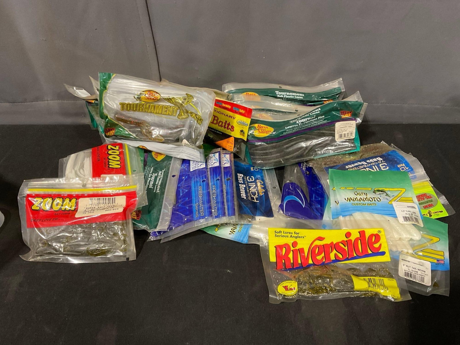 Collection of Soft Plastic Fishing Lures in original packaging, variety of styles, creatures, craws: Appears to be in good shape. The piece measures approx 6h x 15w x 9d inches. See pics. E-5600