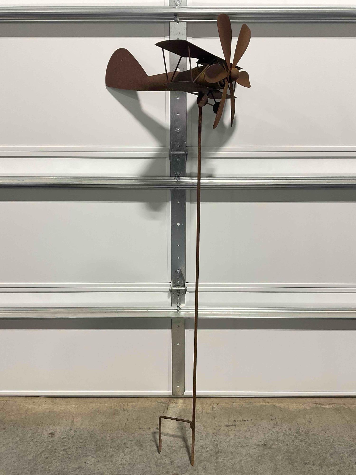Metal Standing Whirligig w/ Biplane Design & Spinning Propellor Lawn Decoration Yard Art. See pics.: Metal Standing Whirligig w/ Biplane Design & Spinning Propellor Lawn Decoration Yard Art. Rusted, has some green growth, otherwise looks to be in good condition. Measures 22" x 17" x 66" DM-5770&n