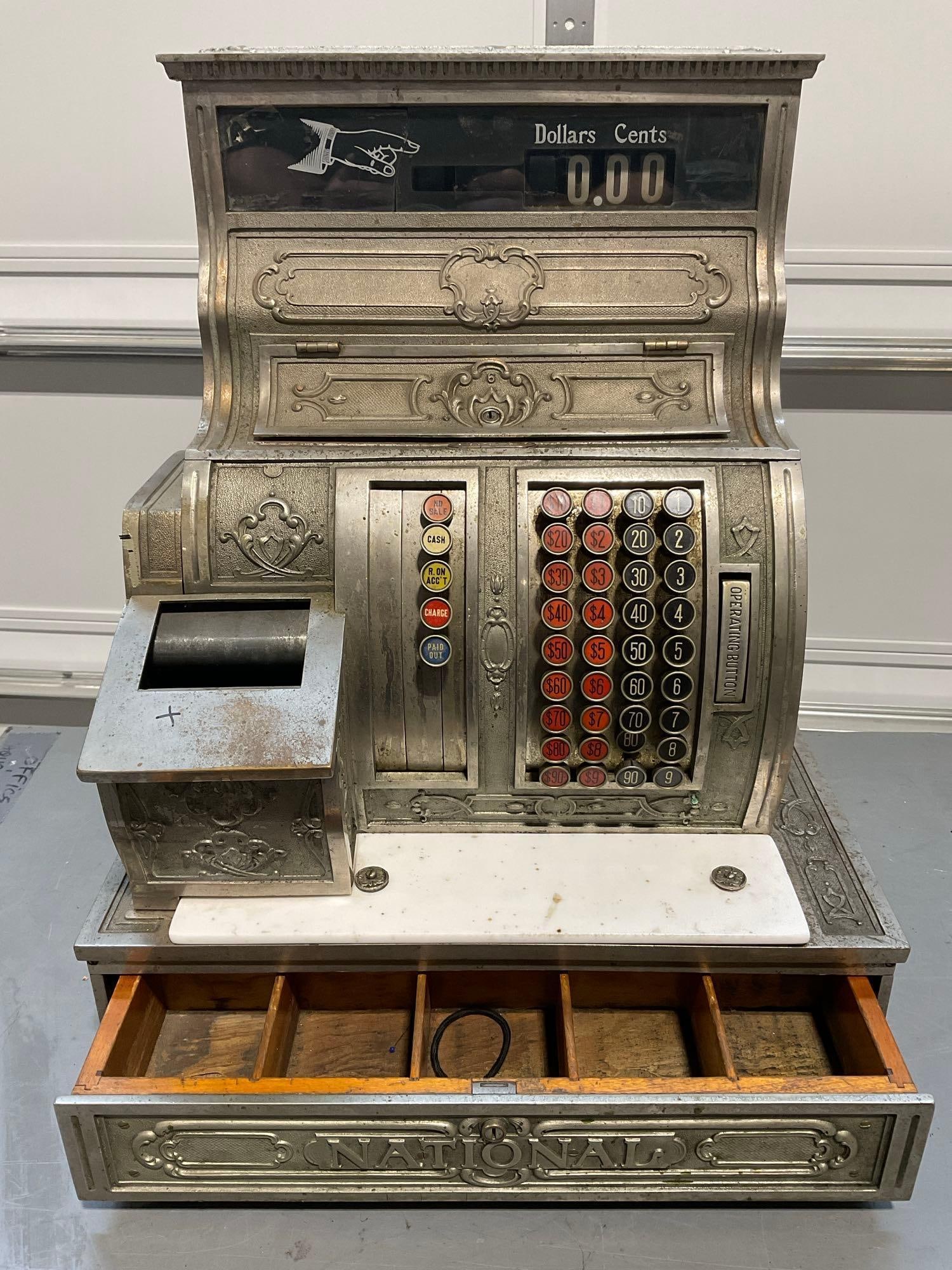 Antique 1917 National Cash Register Co. quite heavy, no key, cast metal construction: Was made originally for Wenatchee Garage, in WA. Size 1054X-G. Appears to be in fair to good shape, some cracks in the front glass panel, some signs of age on the wood cash drawer. Will need some serv
