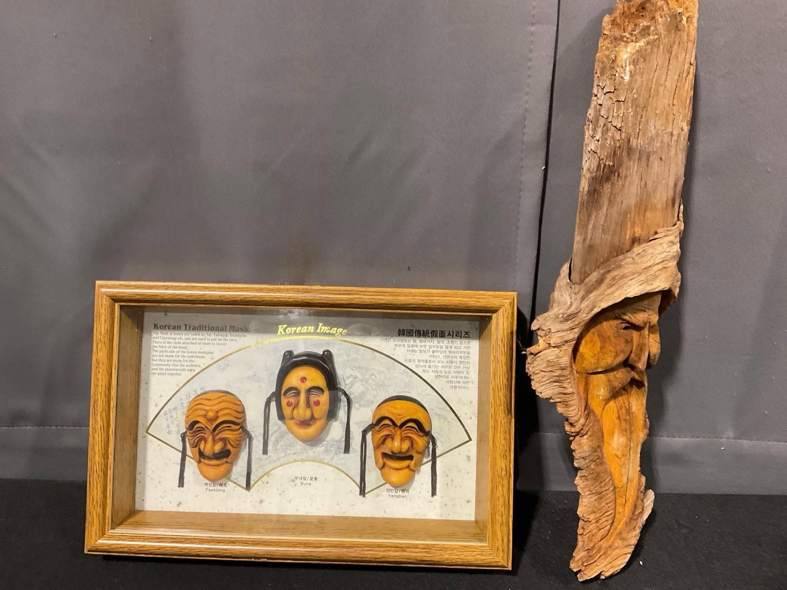 3 Small Korean Traditional Masks in Framed Shadow Box, & Carved Sage Image on Driftwood Log: Appears to be in good shape. The piece measures approx 6h x 17w x 11d inches. See pics. E-5600