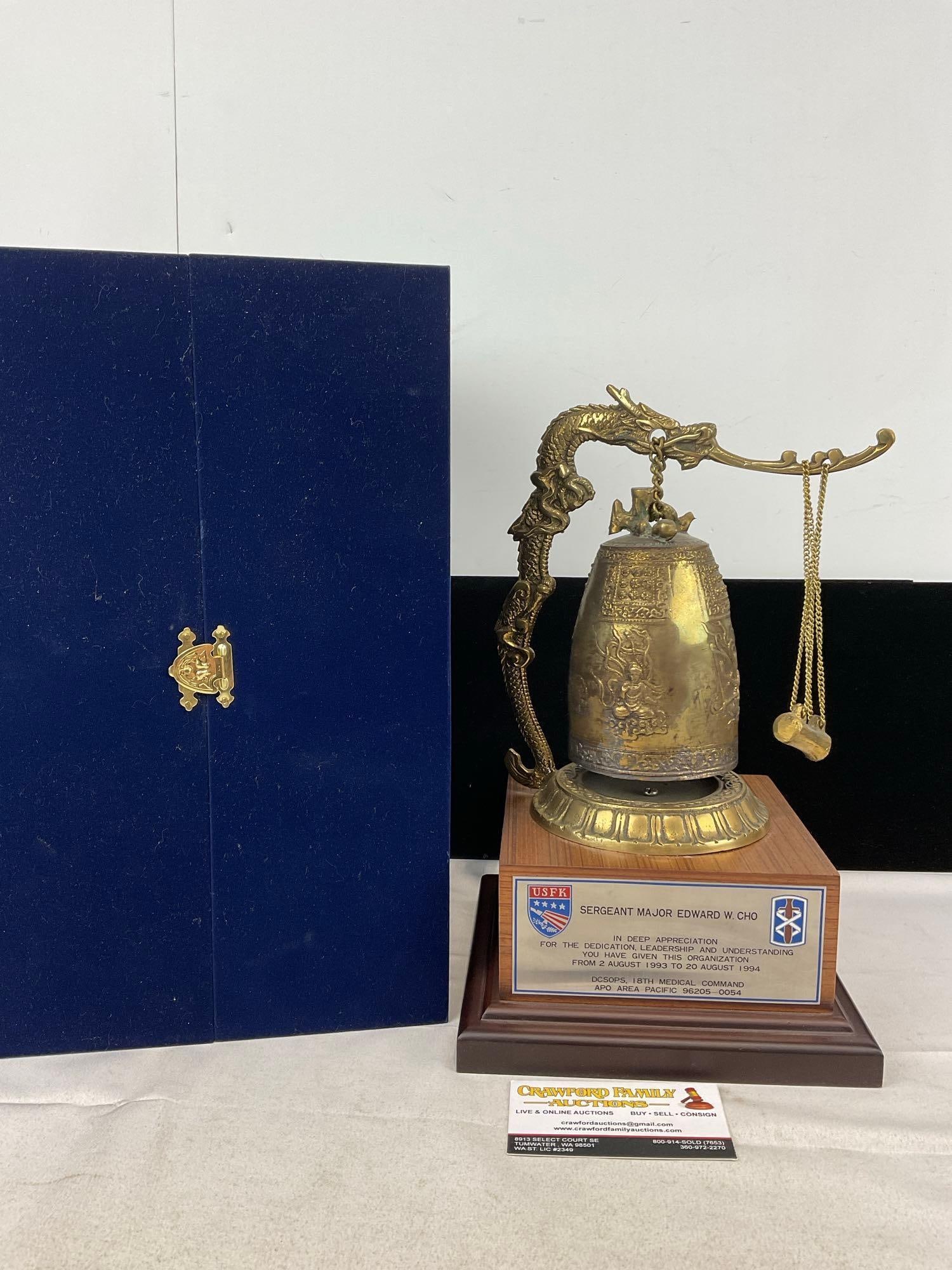 Chinese-style Cast Brass Temple Bell, Figural Dragon Stand, w/military comm. plaque & Blue chest: Appears to be in fair to good shape. The piece measures approx 15h x 10w x 10d inches. See pics. E-5830