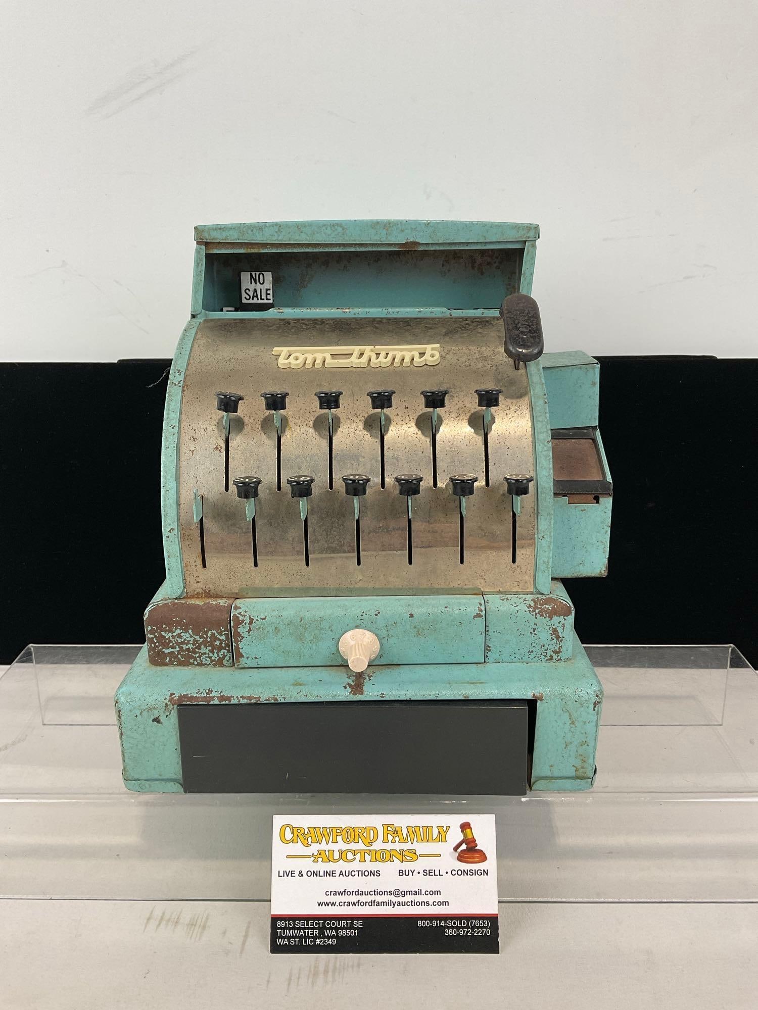 Mid Century Tom Thumb Stamped Metal Toy Cash Register, worn blue finish, 10h x 8w x 8d inches: Appears to be in fair to good shape, some missing finish, seems to function fairly well, one missing button cap. The piece measures approx 10h x 8w x 8d inches. See pics. E-414