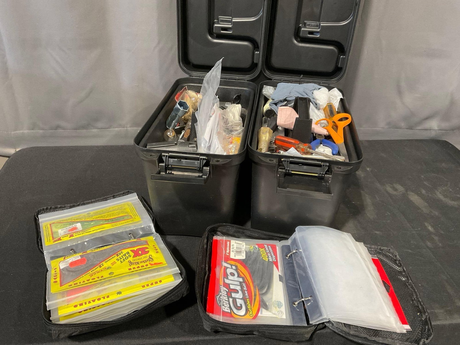 2 Black Heavy Duty Utility Boxes w/fishing supplies, & 2 packs w/an array of Soft Fishing Lures: Appears to be in good shape. The piece measures approx 11h x 16w x 17d inches. See pics. E-5600