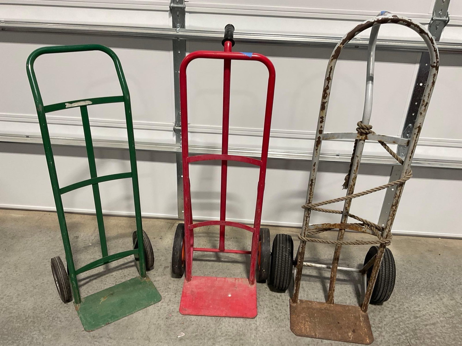 3 Hand Truck Steel Dollys in used shape, Red, Green & Bare Steel, solid & inflatable tires: Appears to be in fair to good used shape. The piece measures approx 52h x 36w x 22d inches. See pics. E-5600 *Freight Required if shipped, Buyer Arranged/Responsibility*