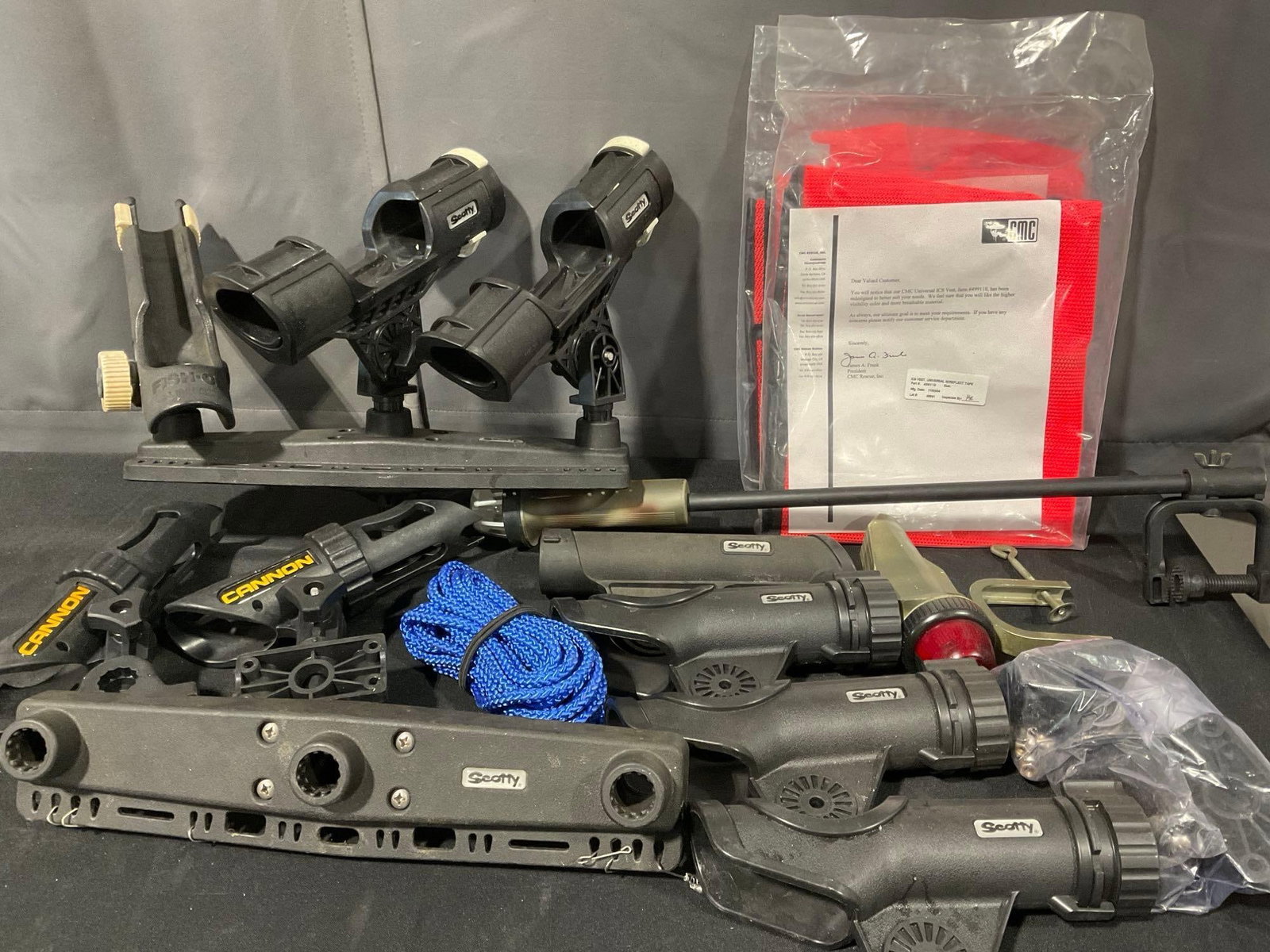 Scotty & Cannon Fishing Pole Holders, w/a few mounts, & 2 safety vests in packaging: Appears to be in good shape. The pieces together measures approx 14h x 20w x 16d inches. See pics. E-5600